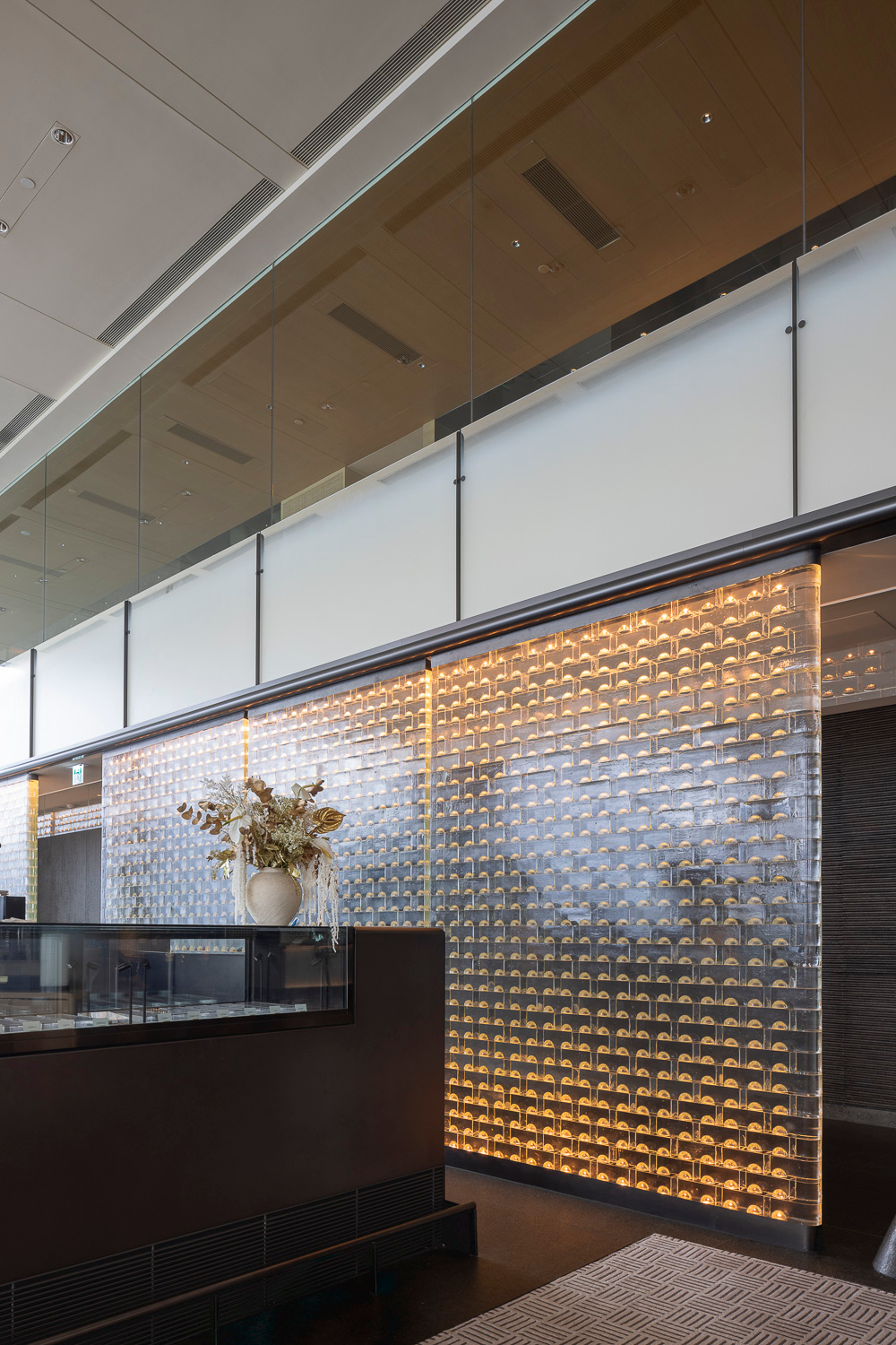 MIDAS illuminated glass screen beside the service counter
