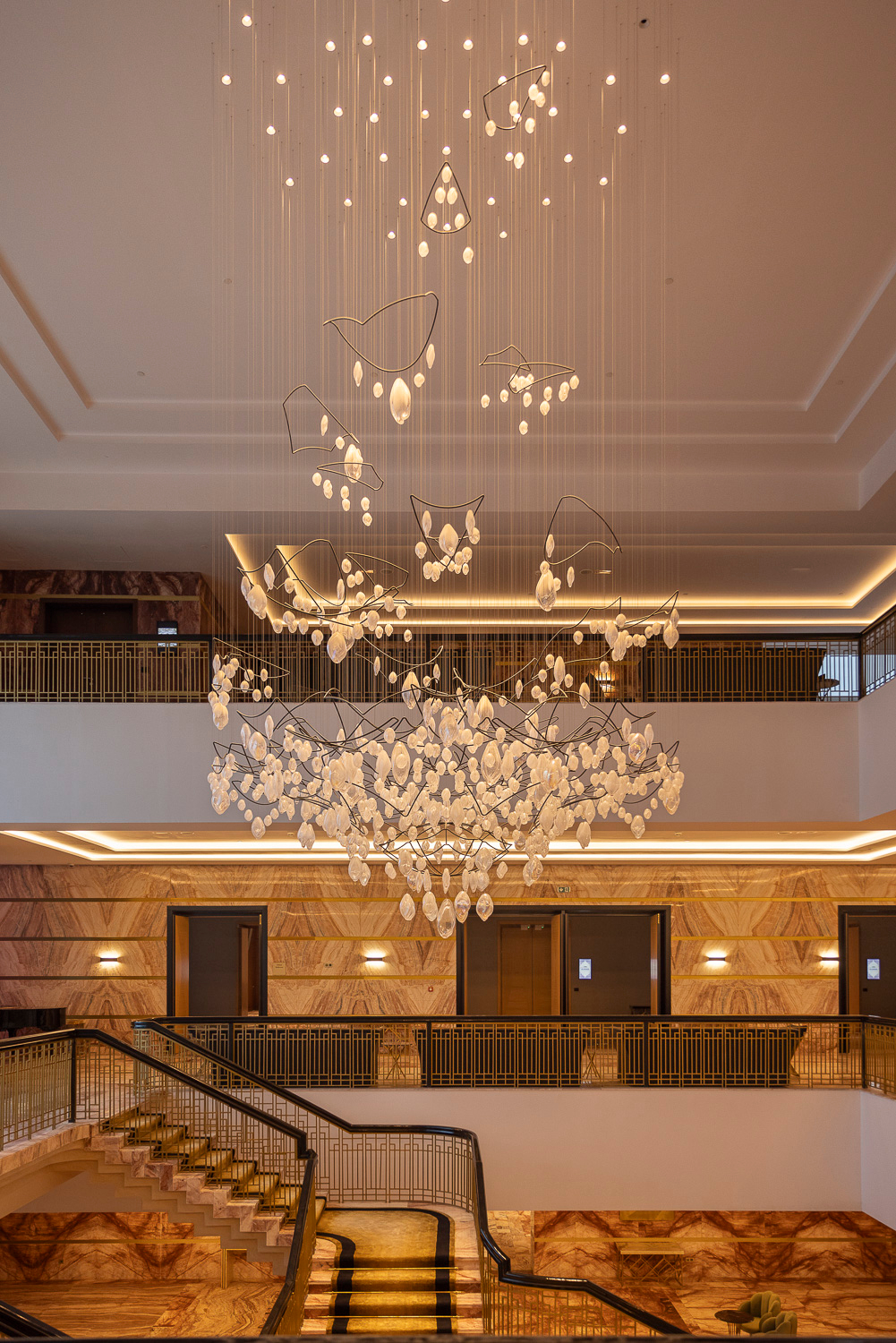 SOLACE chandelier above the lobby staircase