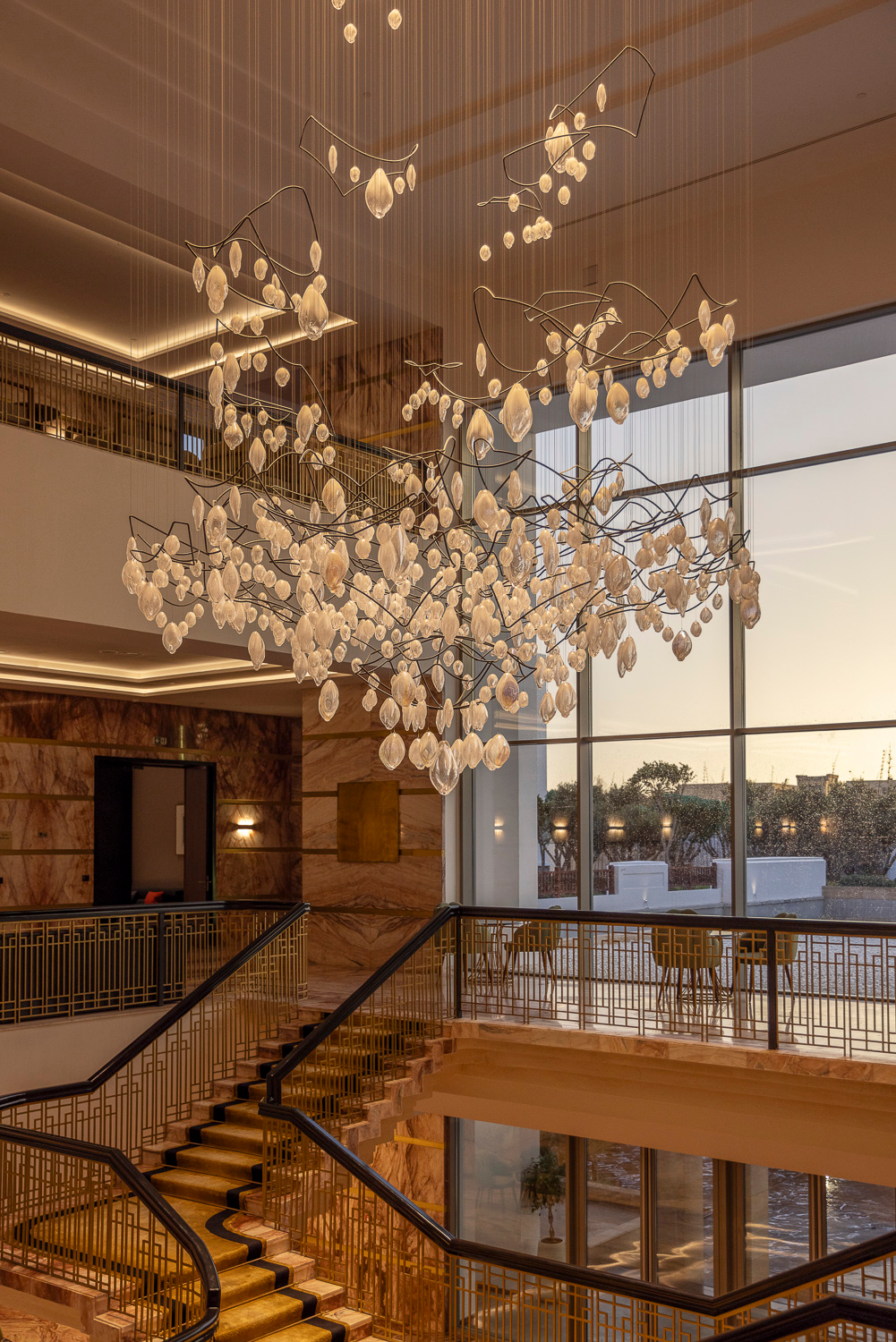 SOLACE chandelier against the evening window wall