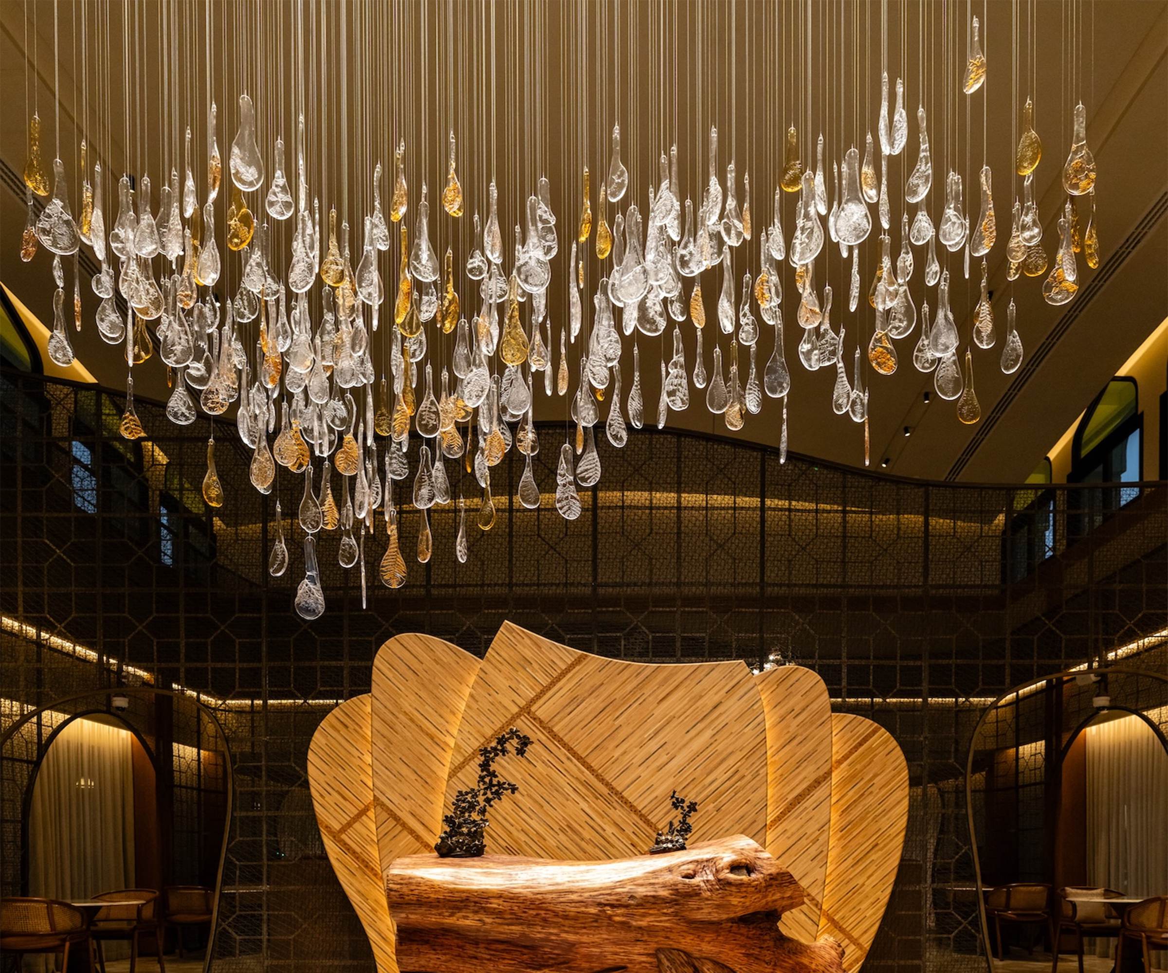 RAINFALL glass droplet chandelier by SHUCHUANG, field seen above the lounge bench