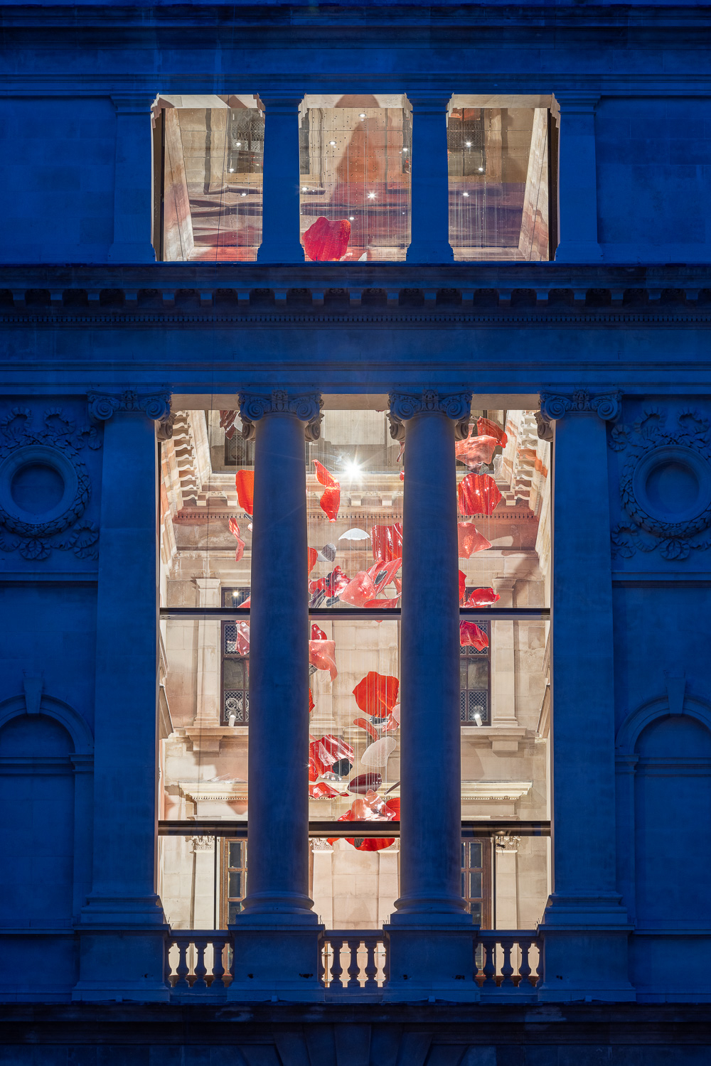 ROSSO red glass installation by SHUCHUANG, seen through the hall windows