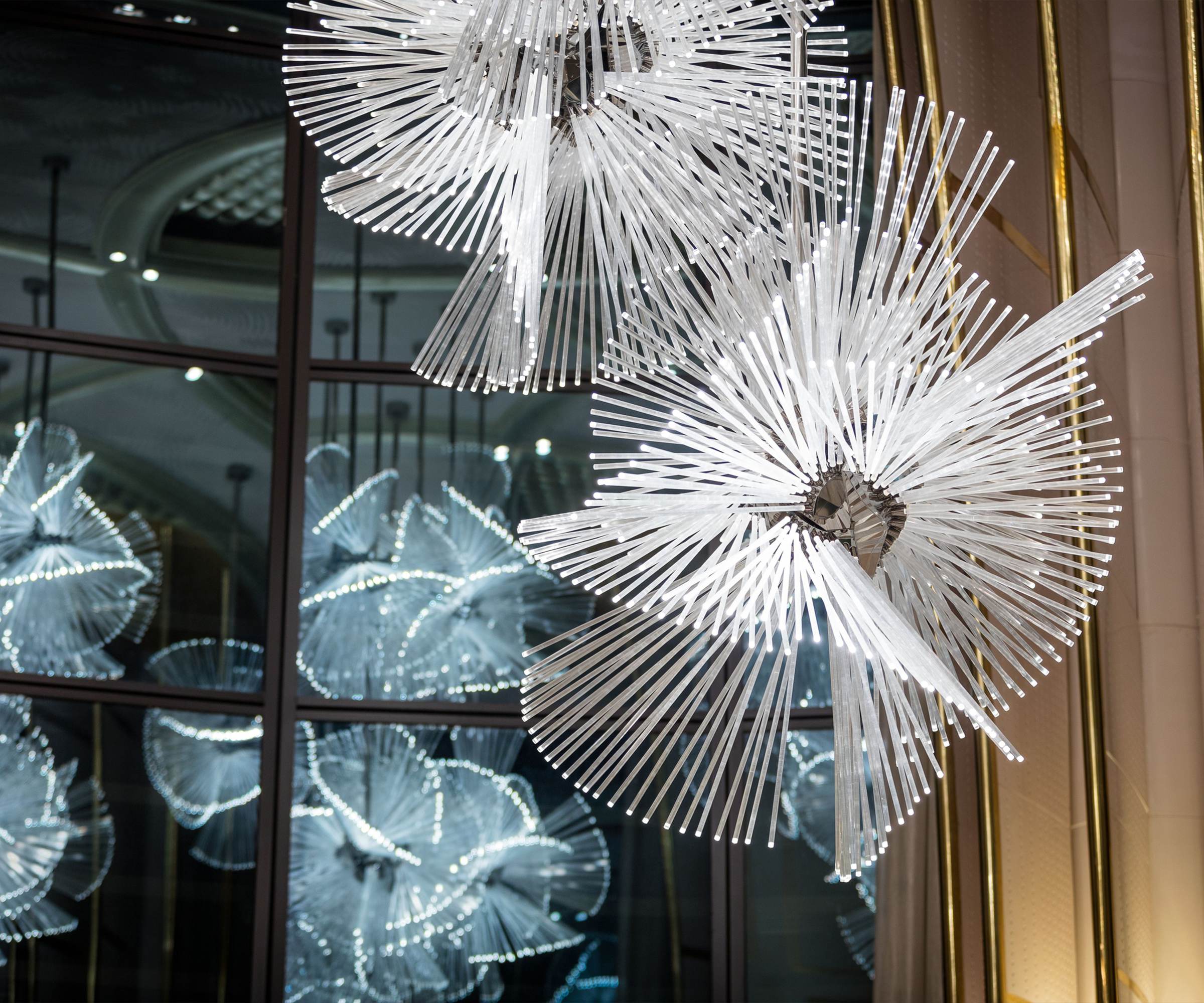 PUFF chandelier, single burst against a window wall