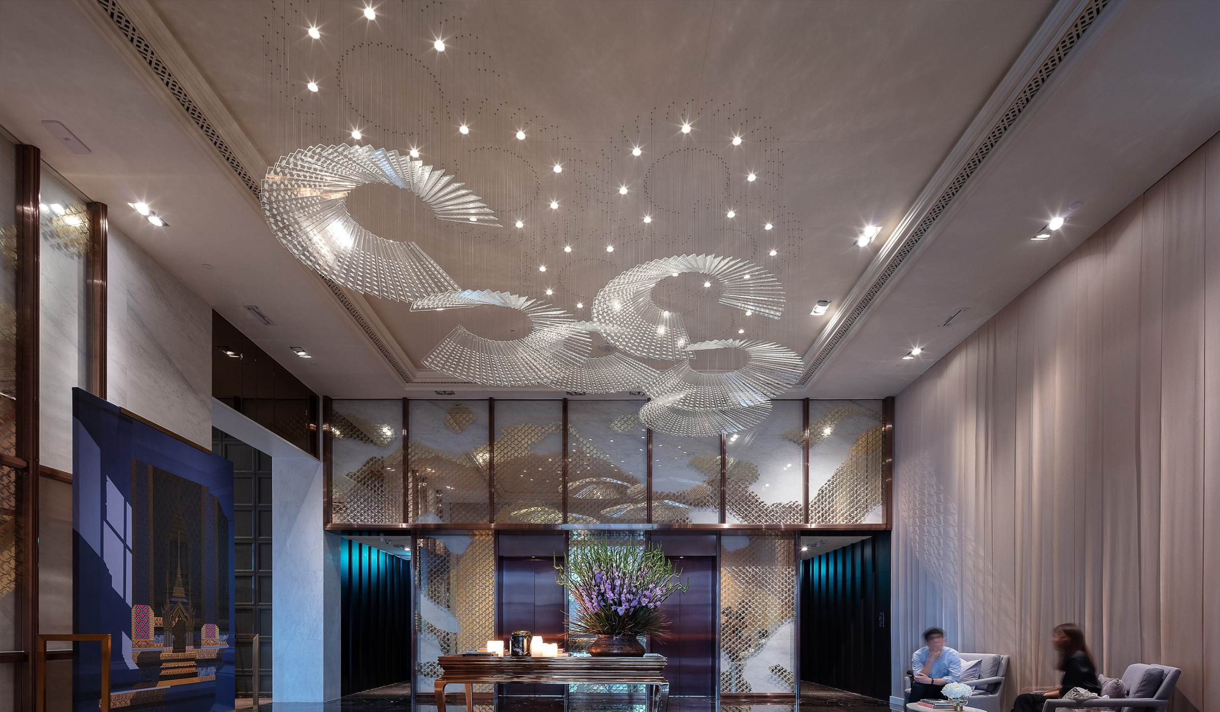 HELIX spiral glass ceiling light by SHUCHUANG, fans turning across the reception ceiling