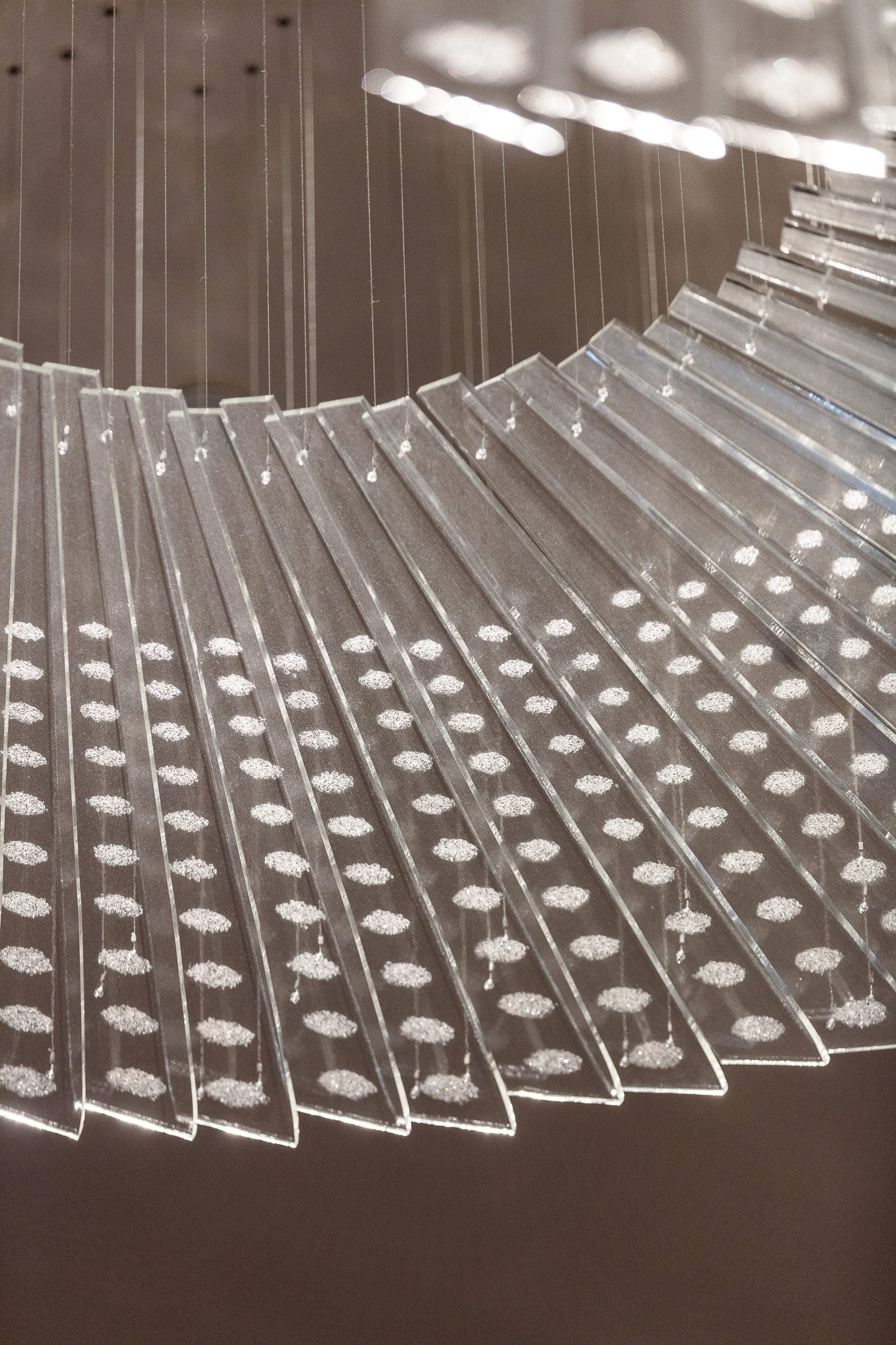 HELIX glass fans against the window wall at night