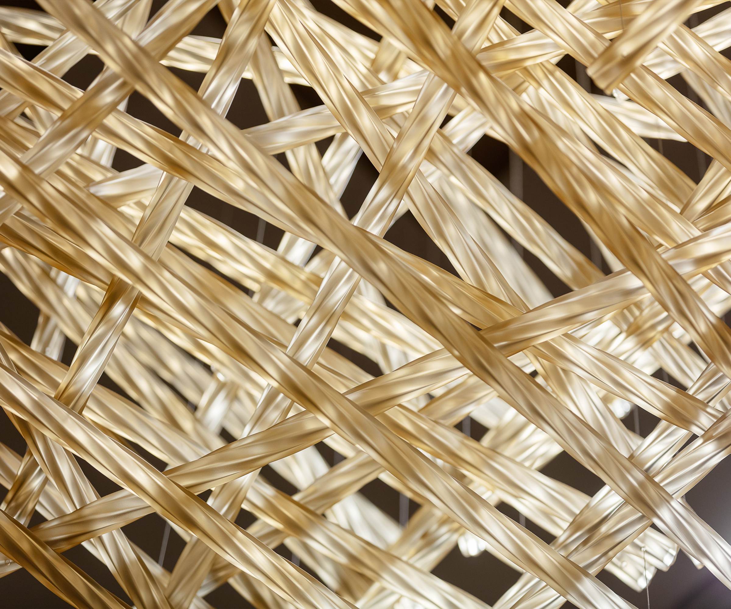 WOVEN gilded battens crossing at all angles, close view