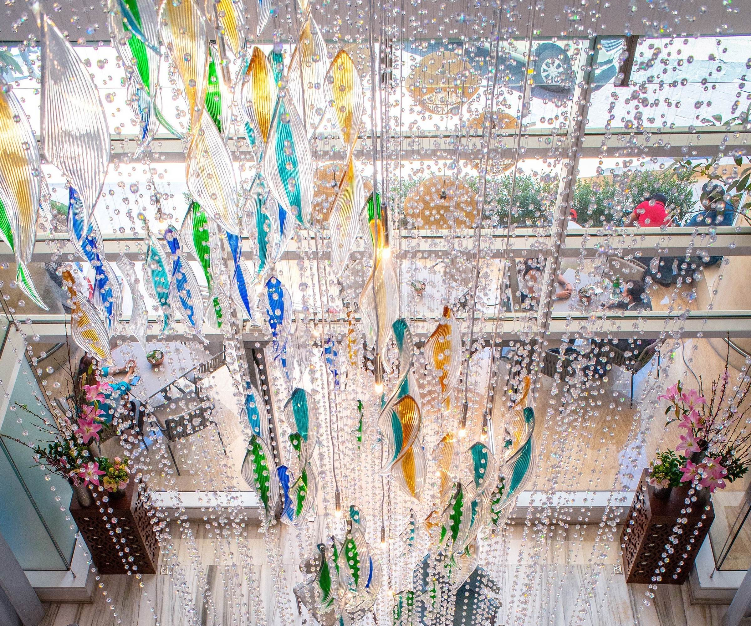 VIBRANT full-height glass chandelier by SHUCHUANG, coloured glass falling through a clear bead curtain