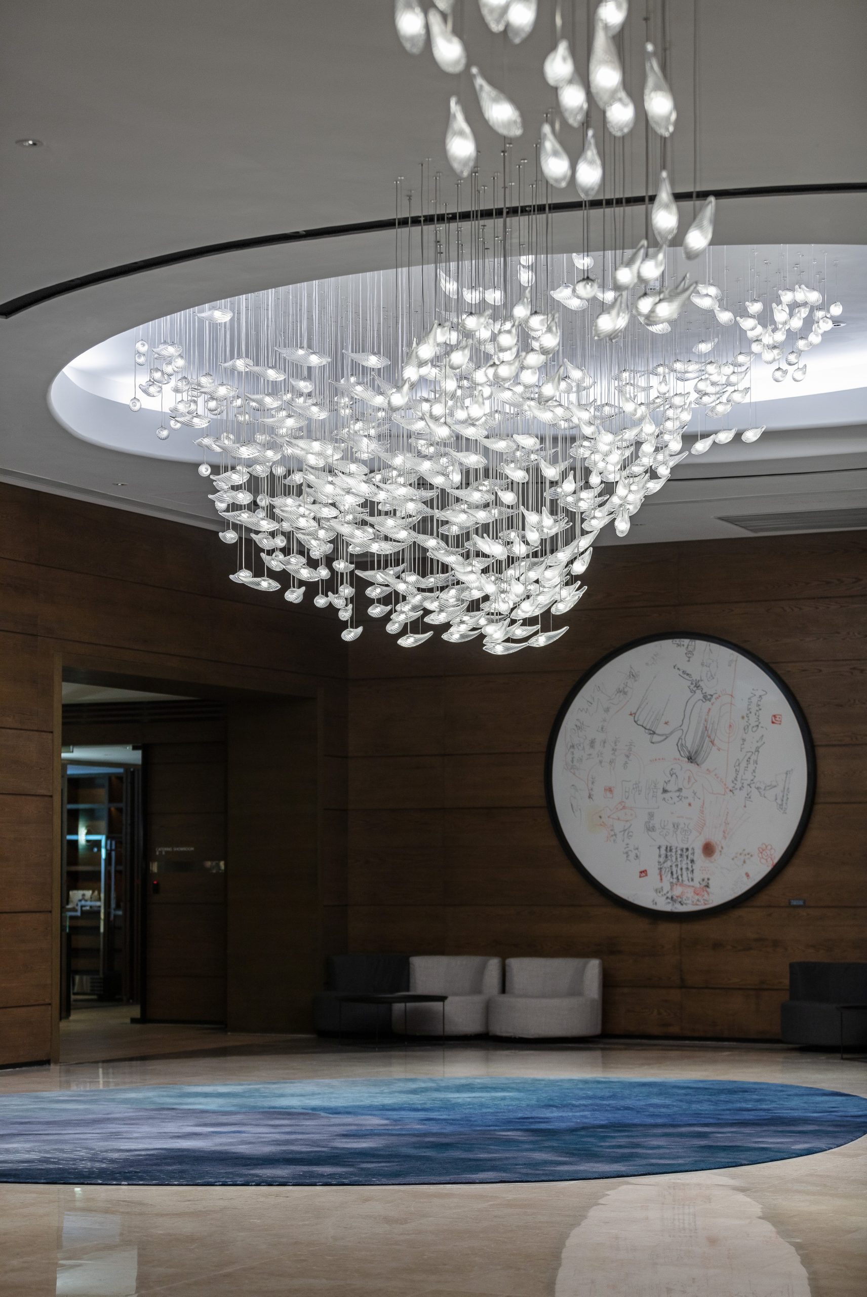 CONCH crystal shell chandelier by SHUCHUANG, oval loop across a domed reception ceiling