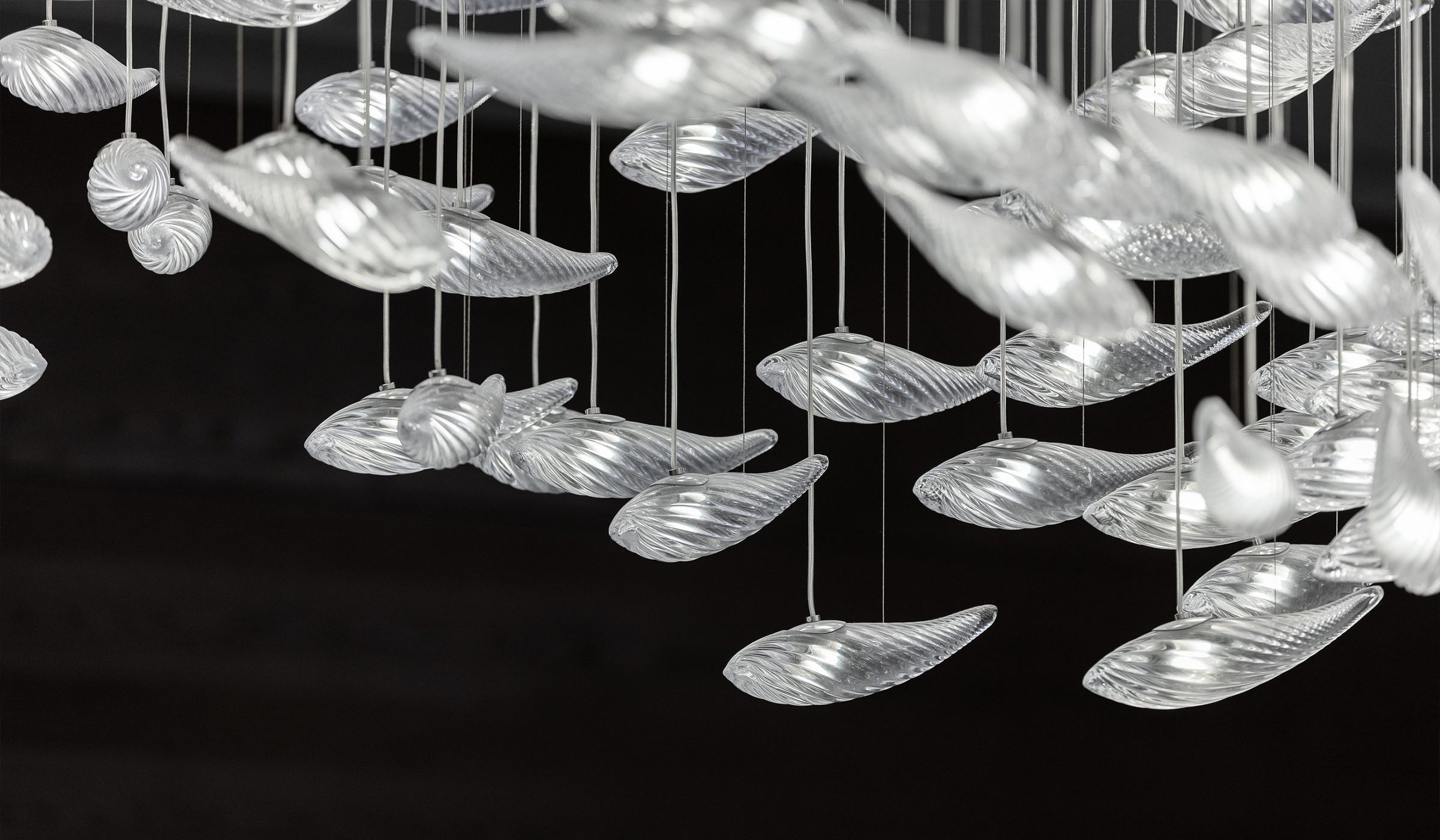 CONCH chandelier seen against the domed ceiling