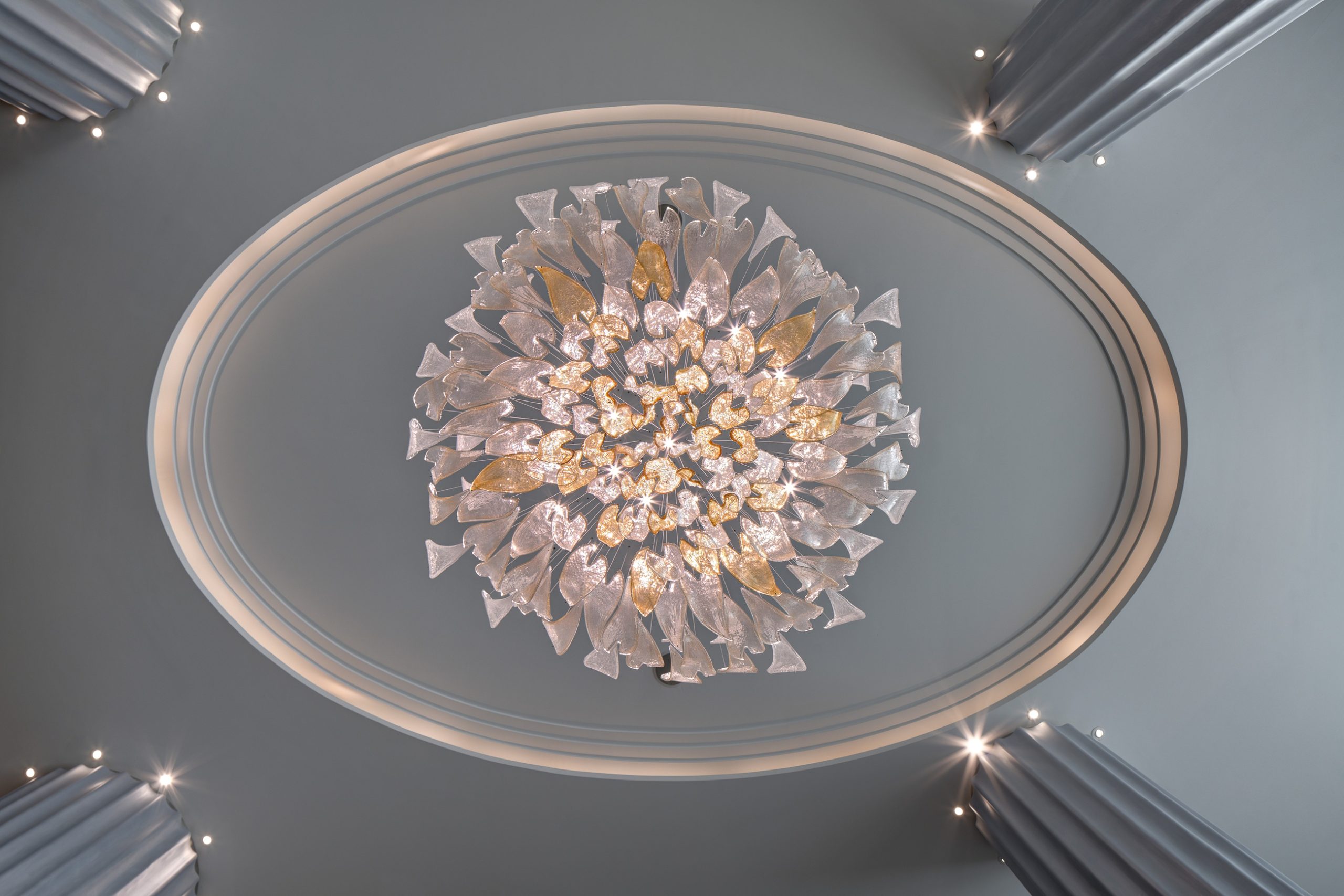 GOLDFINCH crystal leaf chandelier by SHUCHUANG, rising around a stair hall