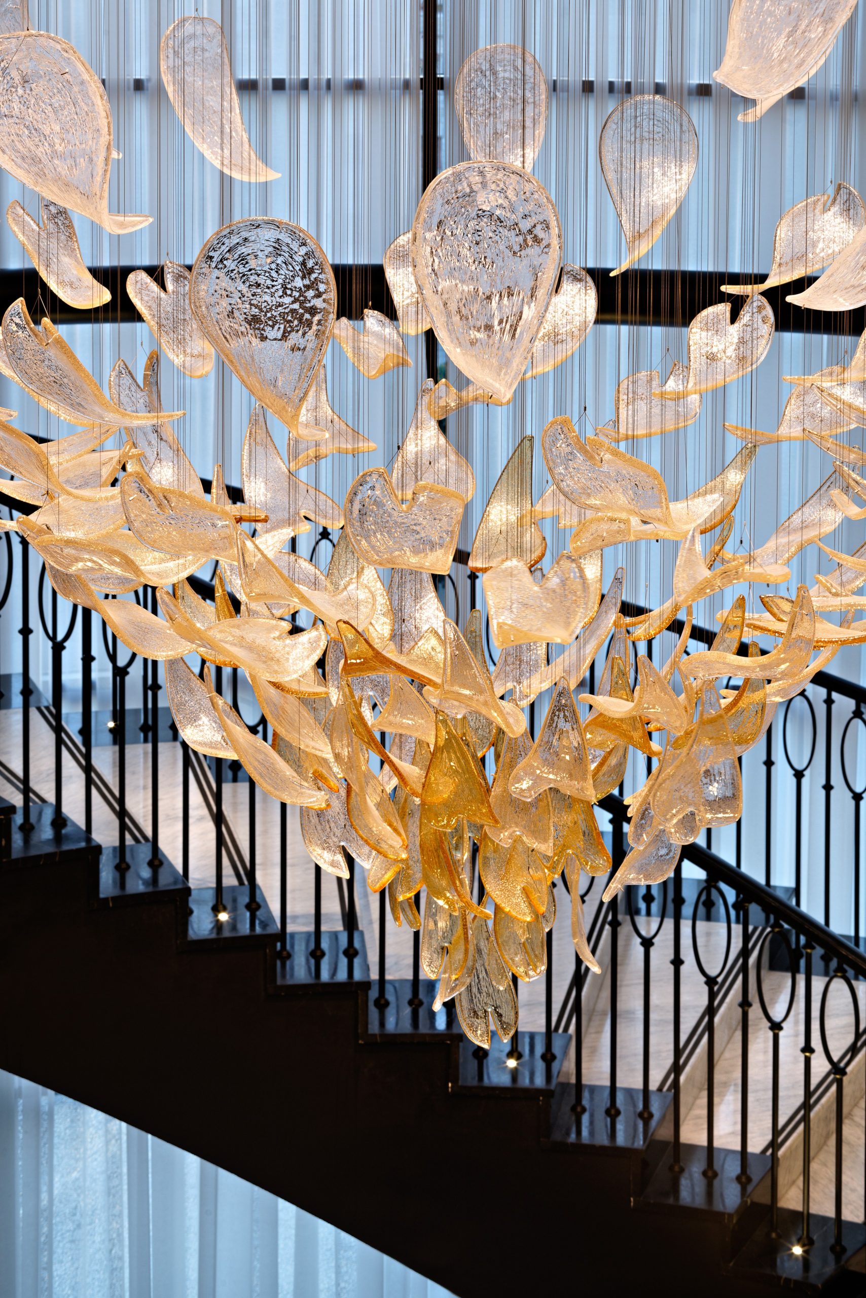 GOLDFINCH chandelier seen over the staircase