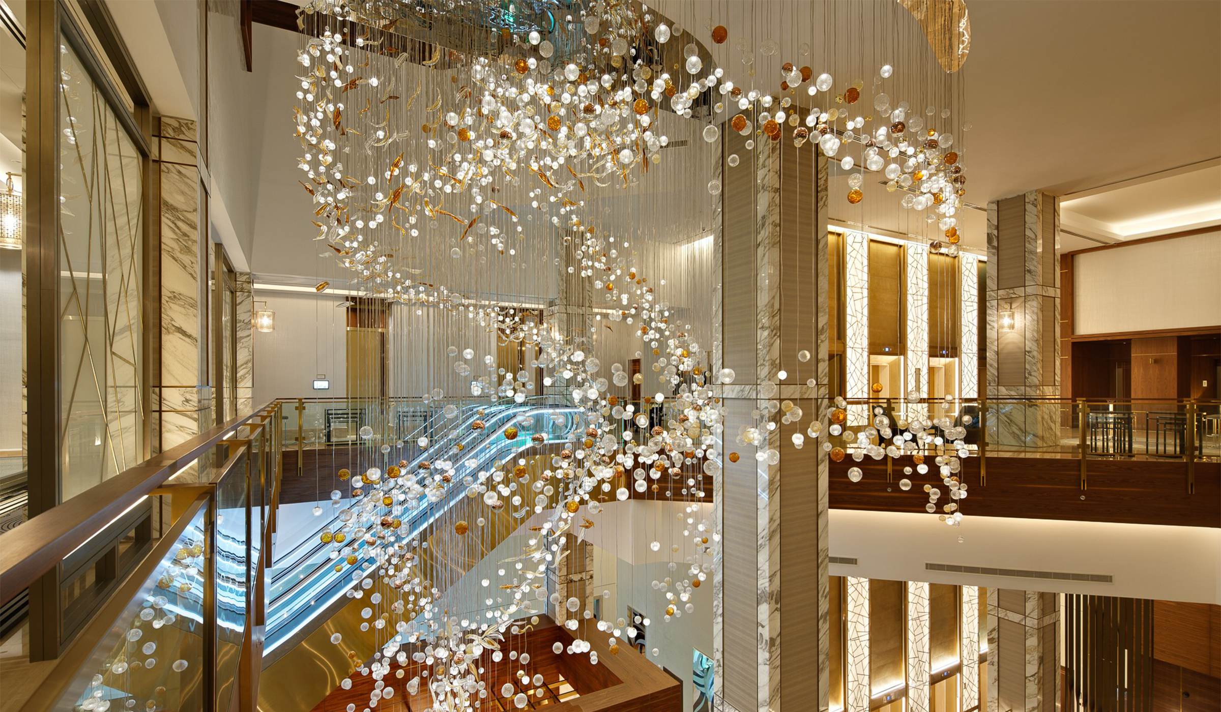 COSMIC bubble glass chandelier by SHUCHUANG, arc sweeping through the atrium