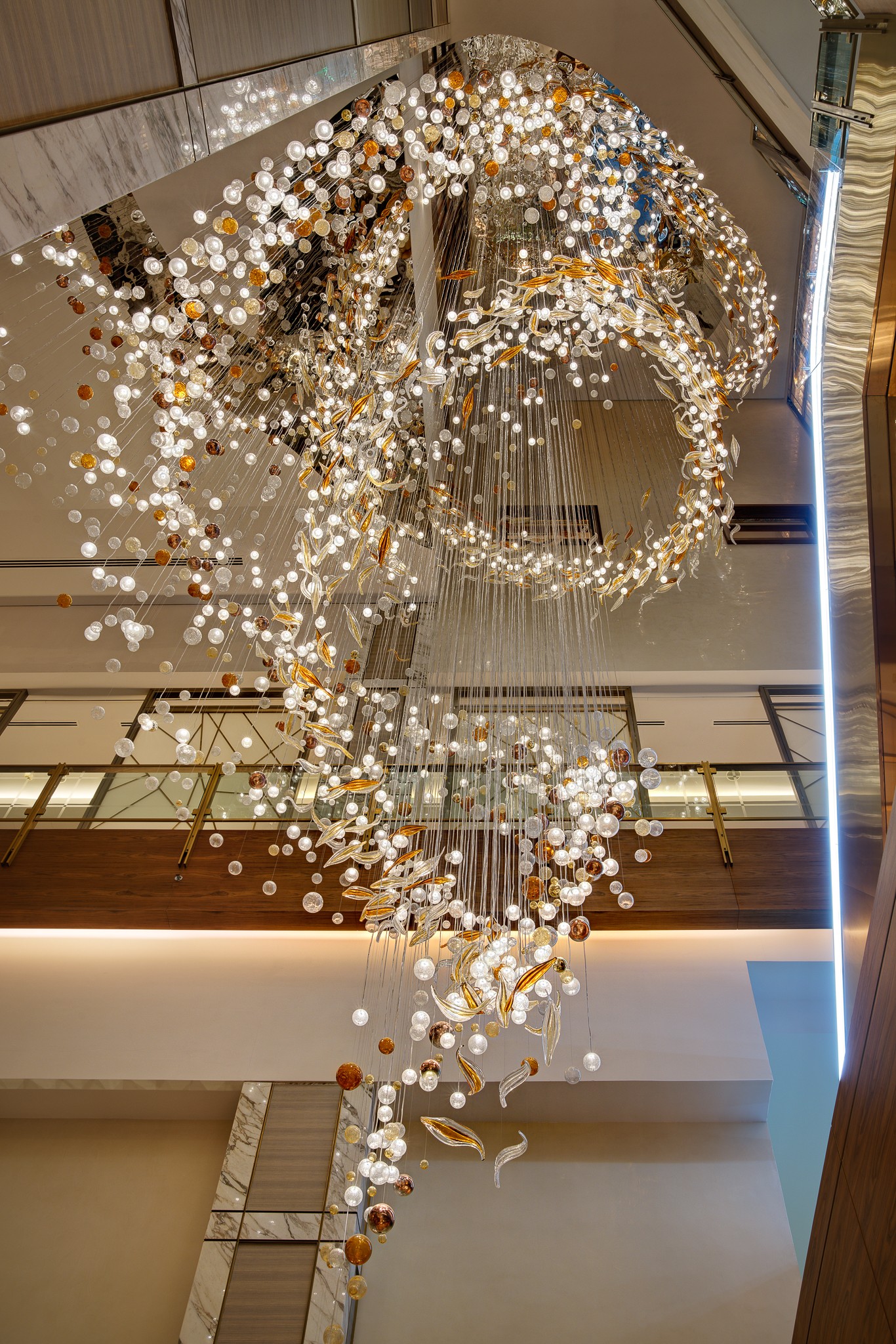 COSMIC bubble chandelier against the marble column