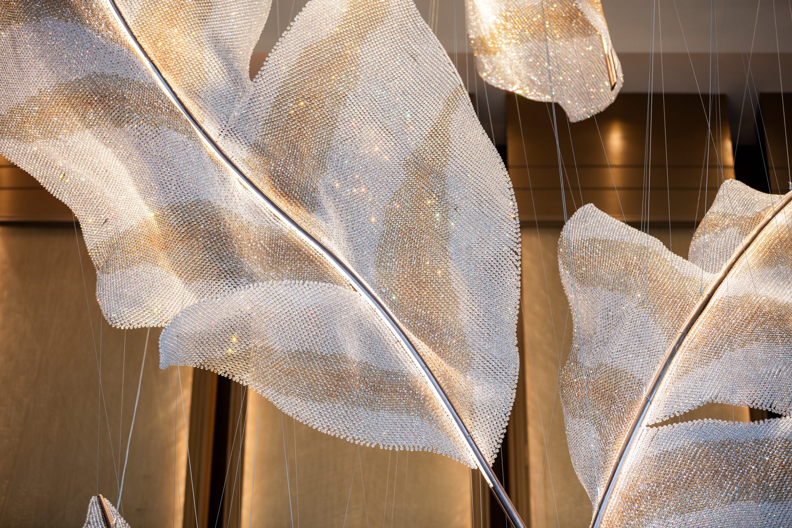 ARIA feather chandelier, close view of the spine and mesh edge