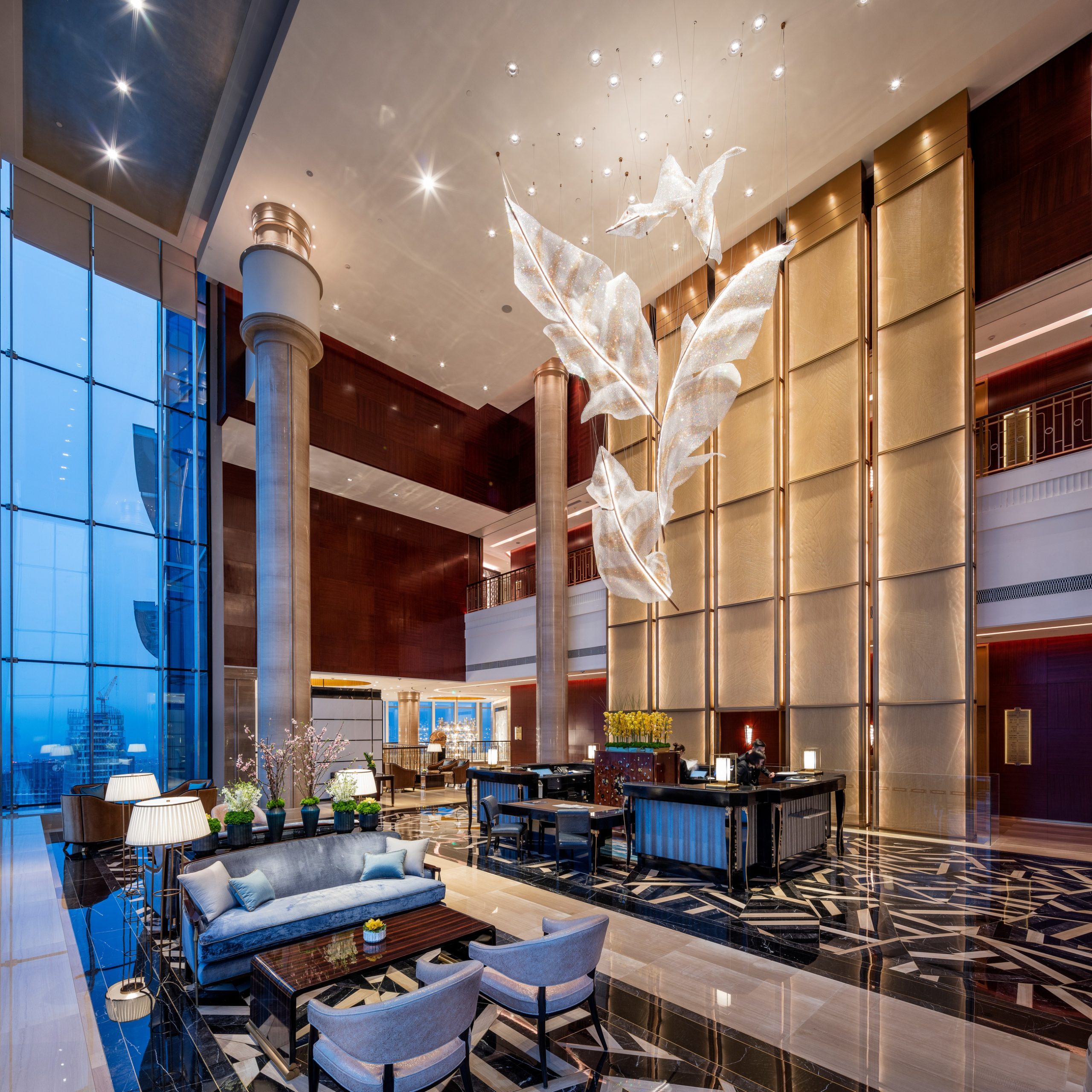 ARIA chandelier, wide lobby view with the window wall behind