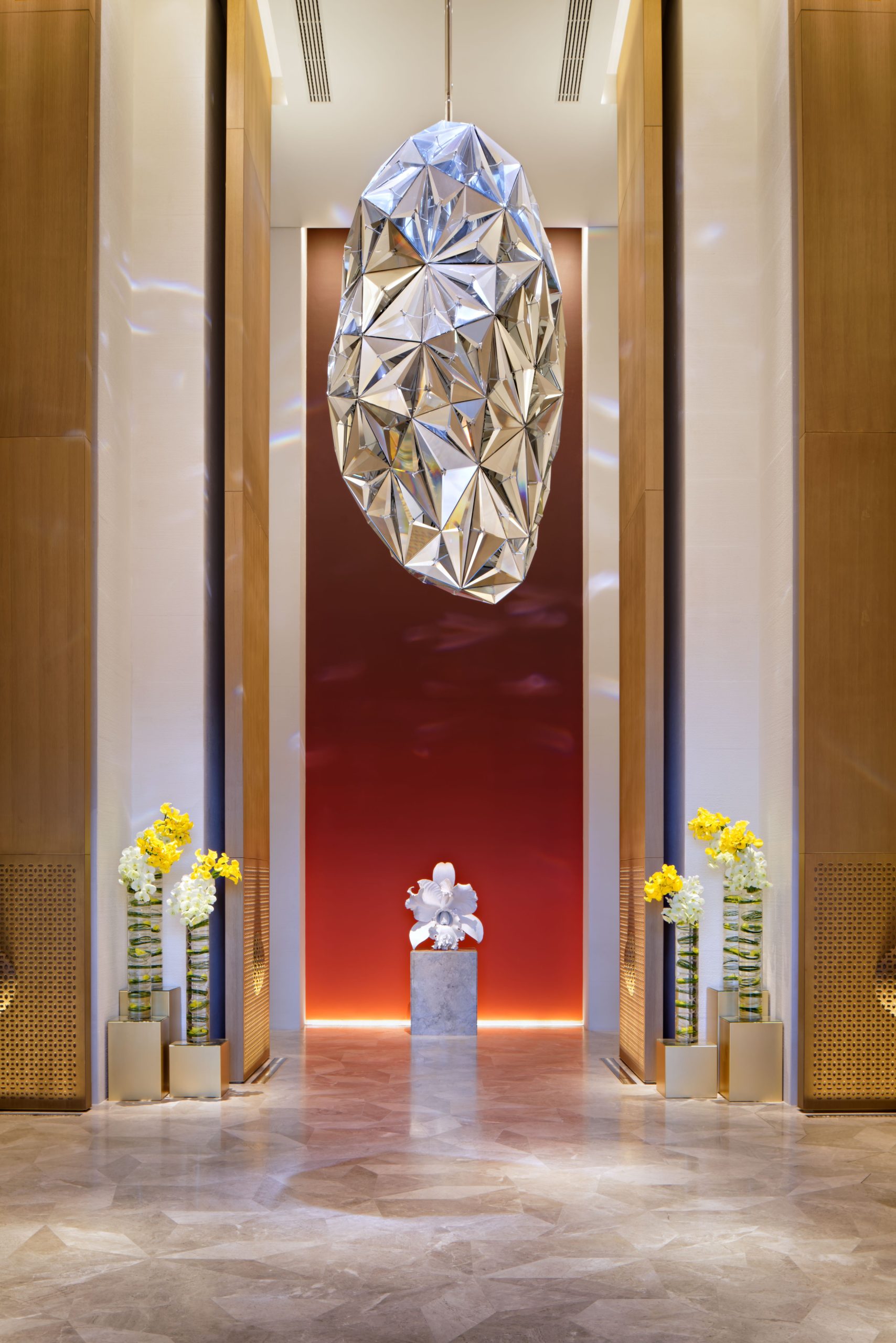 DIAMANTE pendant light hanging in a tall entrance corridor