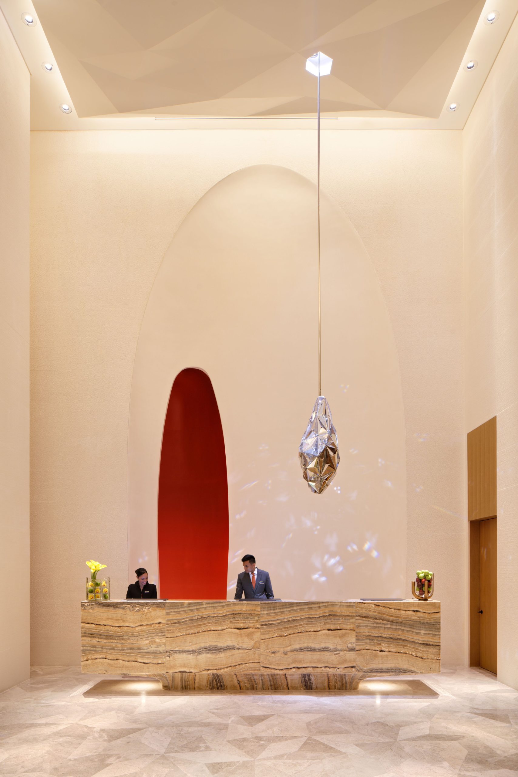 DIAMANTE faceted pendant light above a hotel reception desk