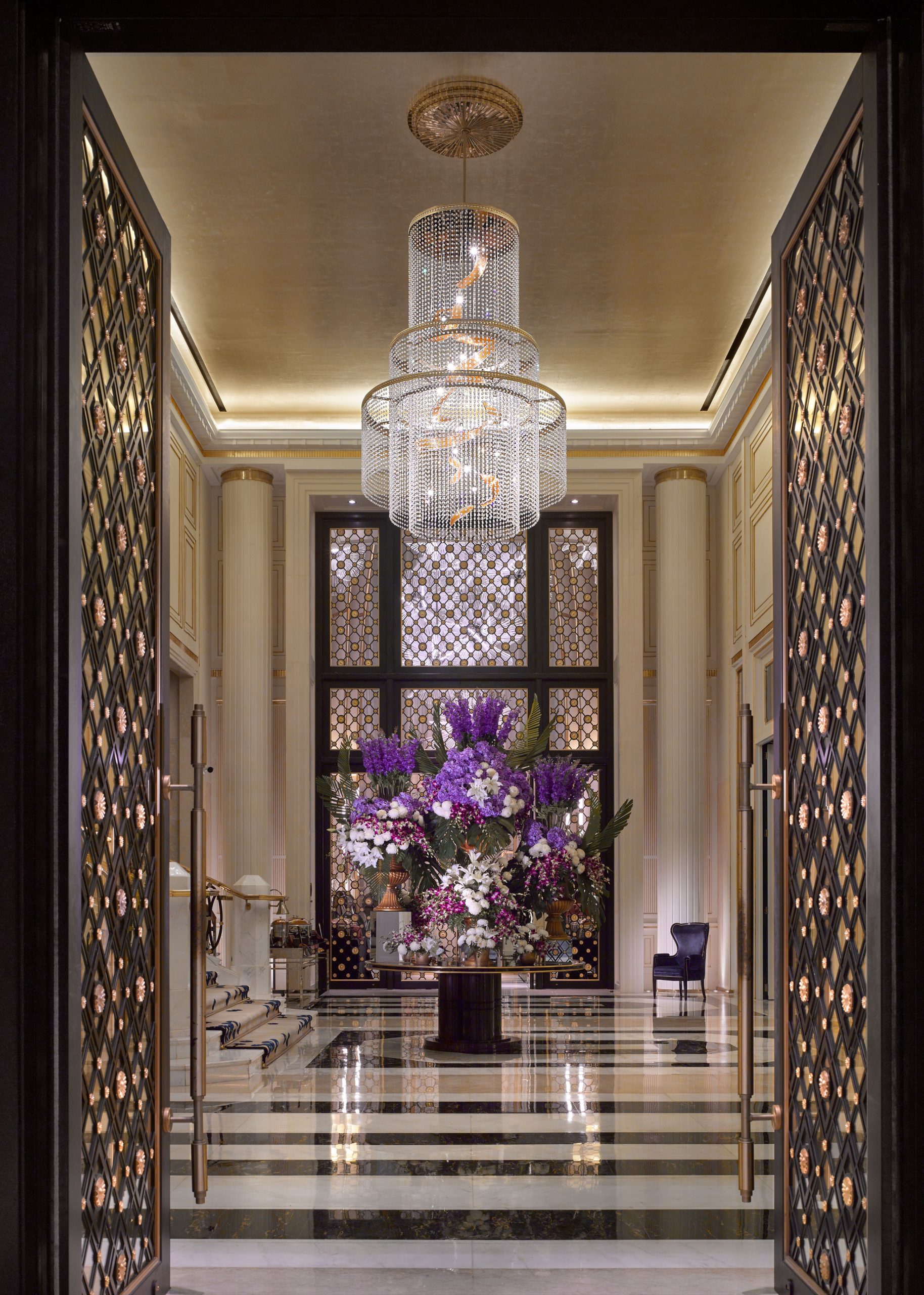 EMPIRE tiered chandelier seen through the hall screen