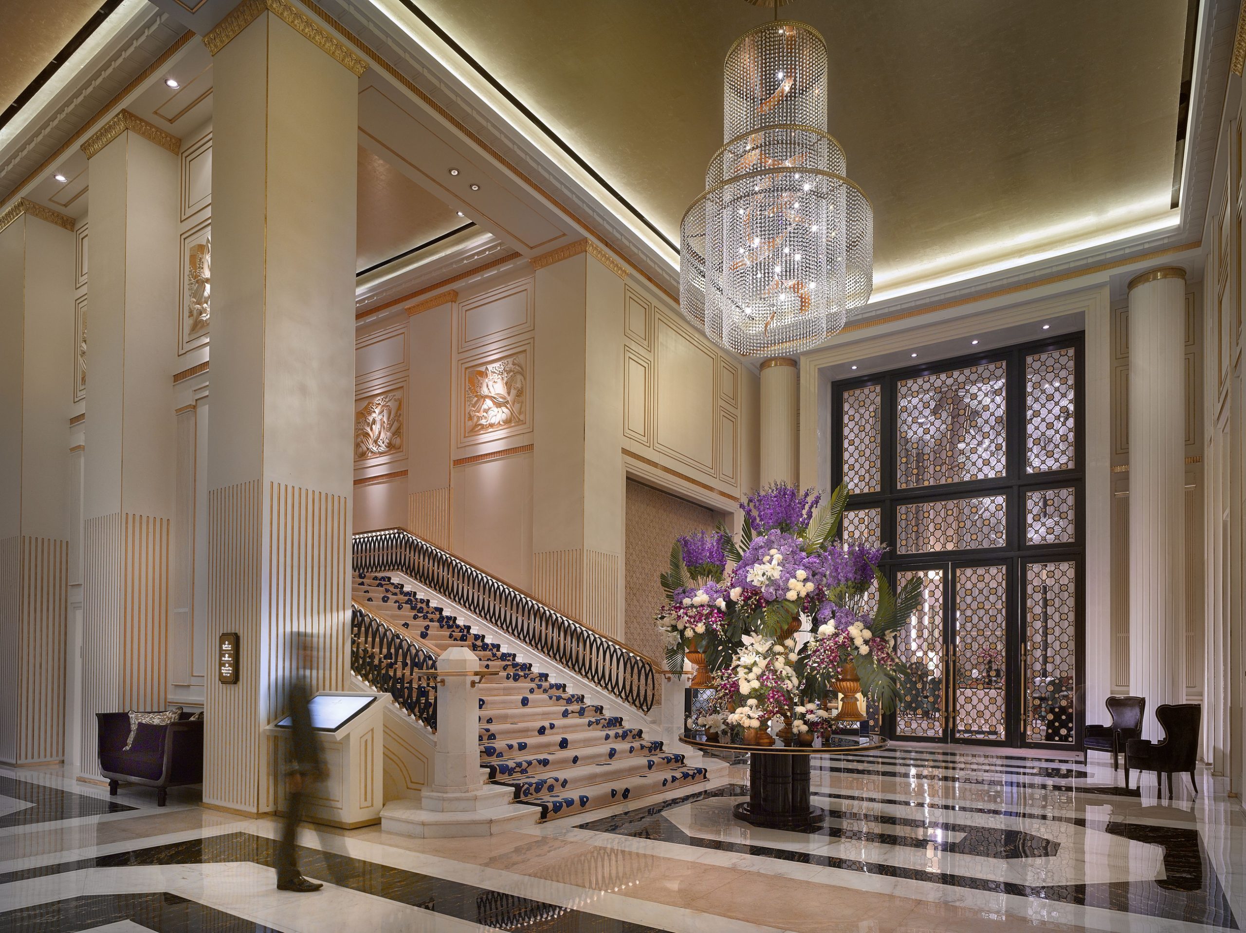 EMPIRE tiered crystal chandelier in a hotel stair hall