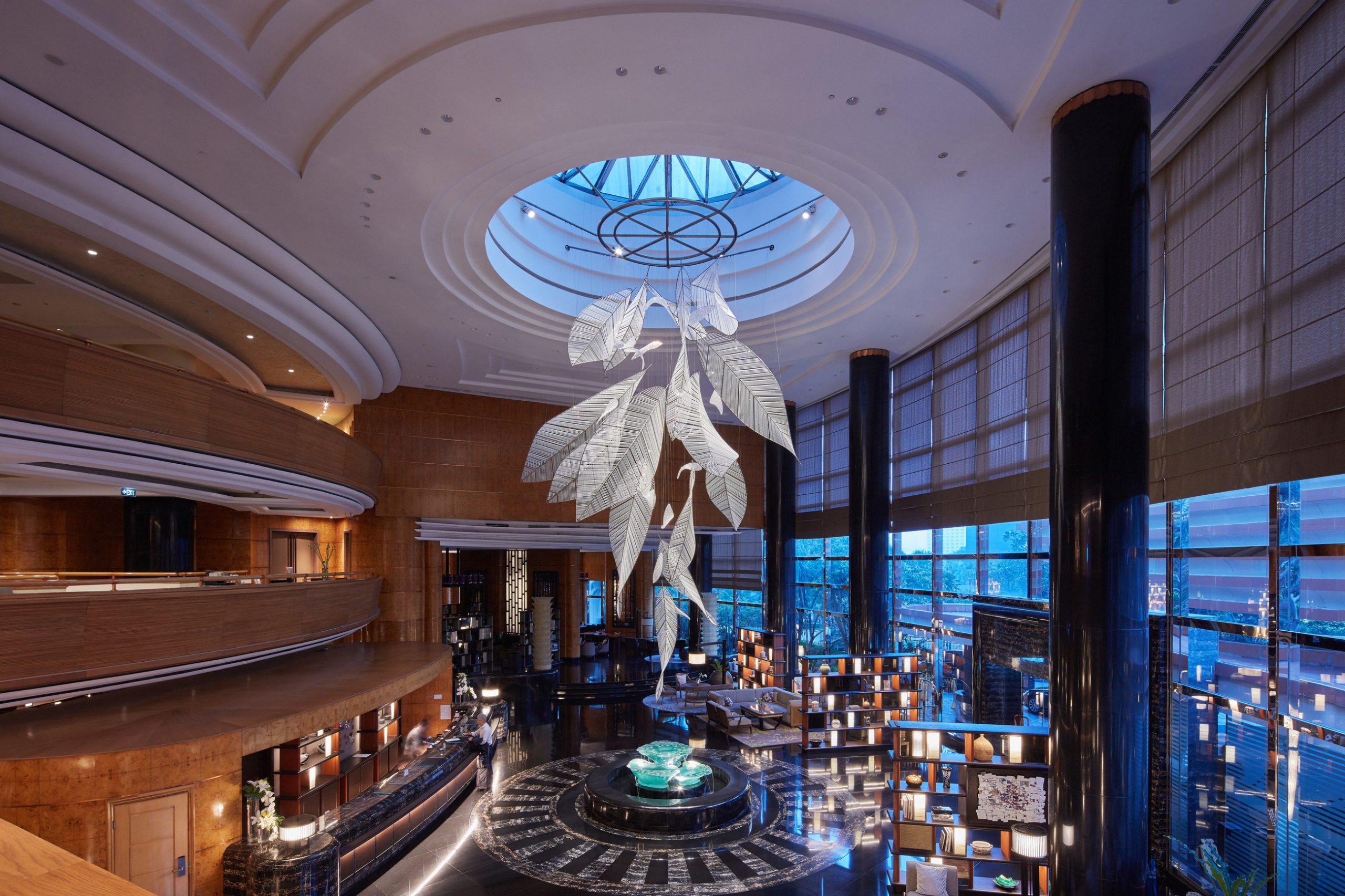 FOLIA crystal leaf chandelier above the lobby seating
