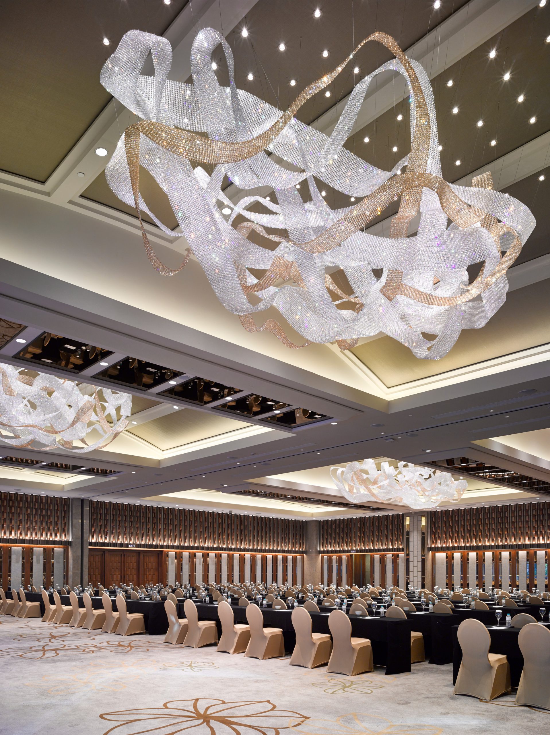 NEXUS ribbon chandelier above a set banquet hall