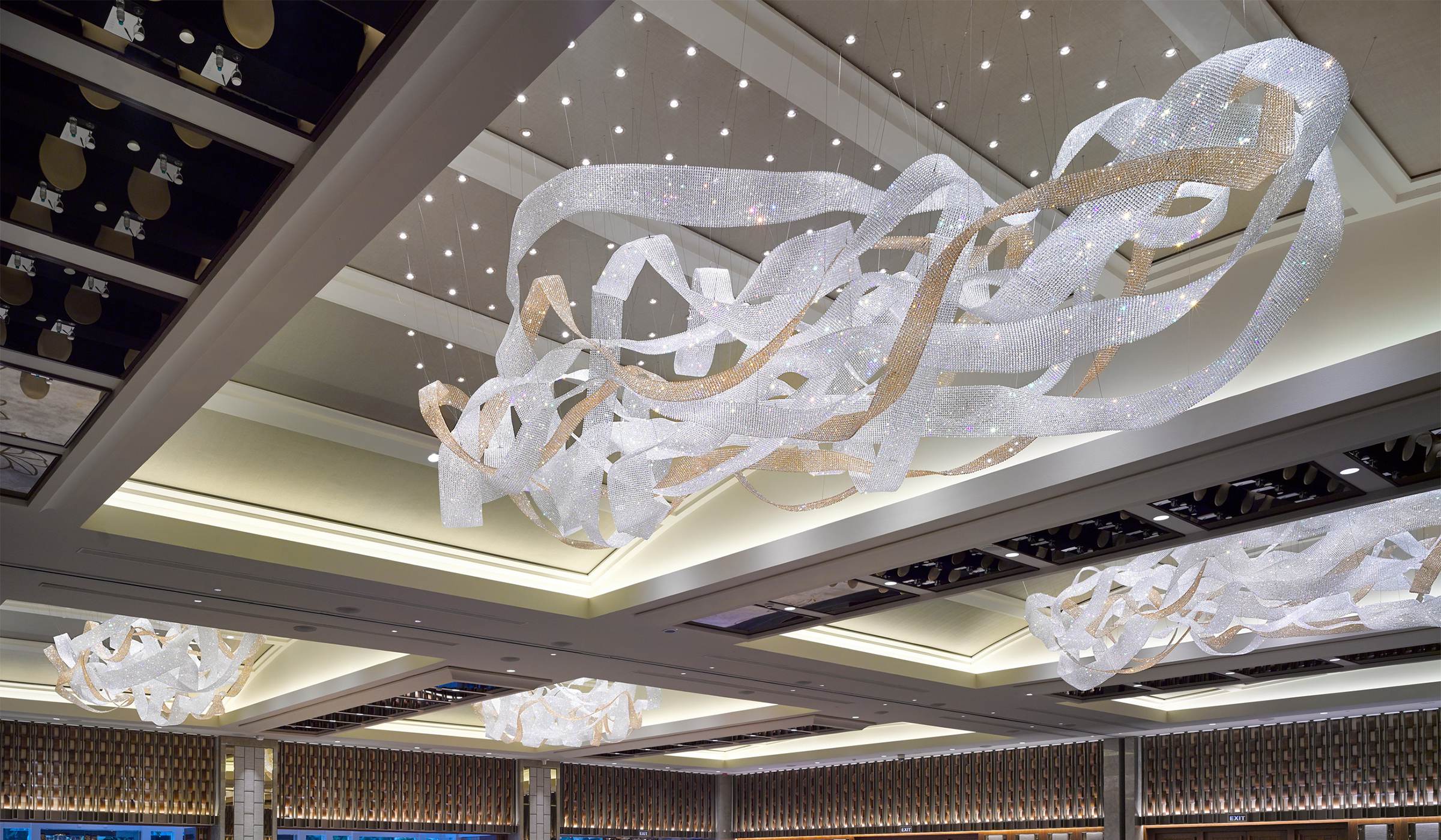 NEXUS ribbon chandelier seen from below, bands folding through one another