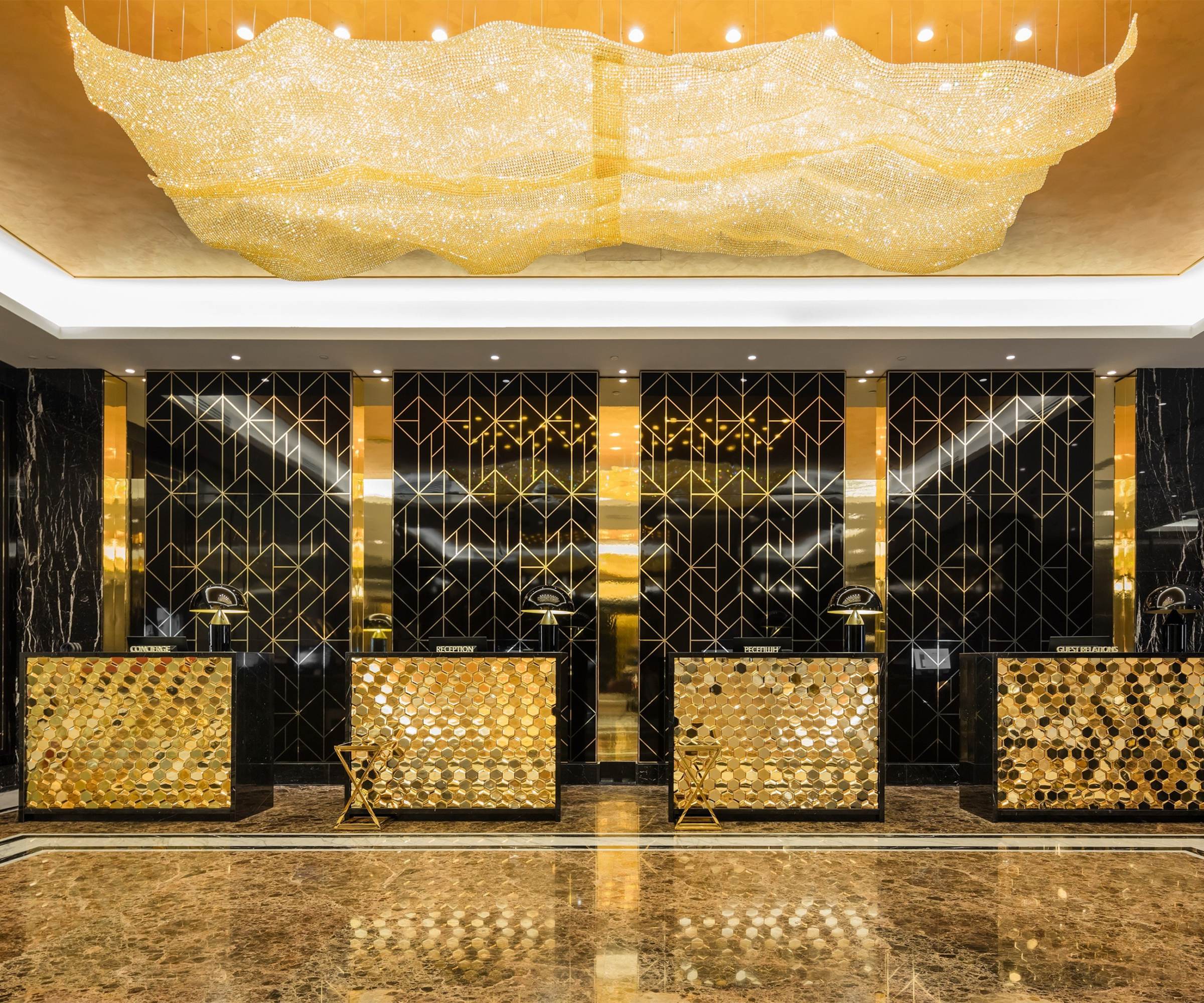 AURORA ceiling light above a hotel reception desk
