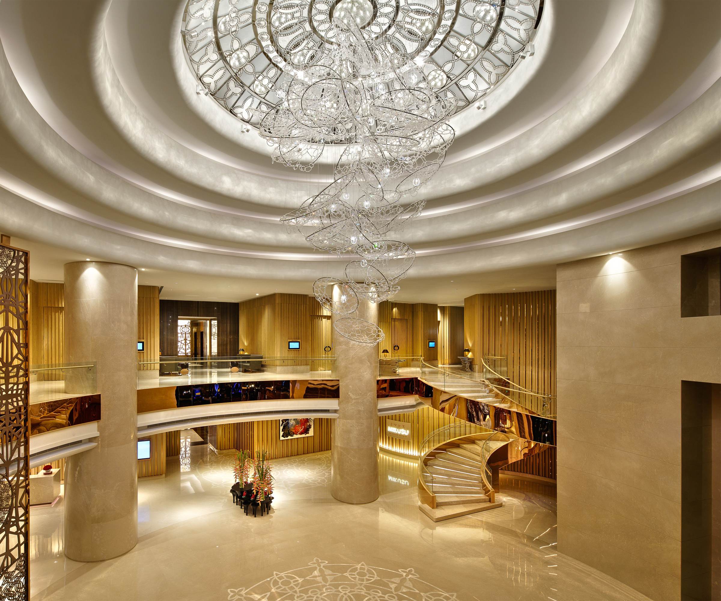 CIRRUS chandelier spiralling through a hotel lobby rotunda