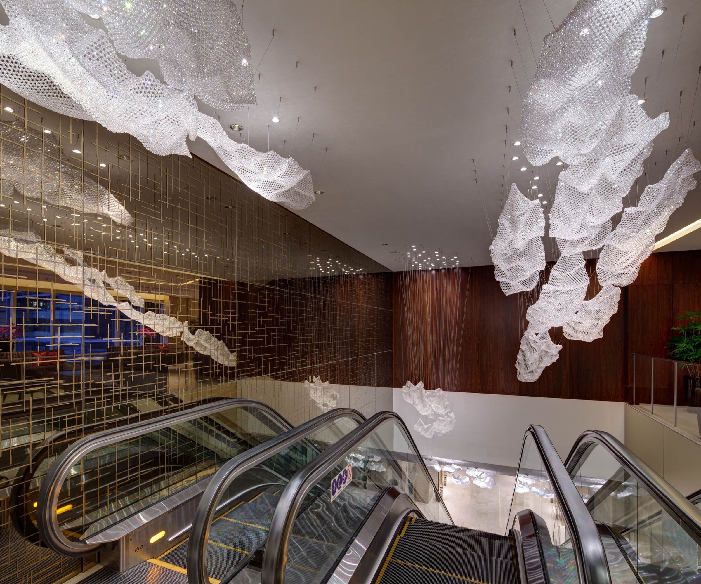 CELESTE crystal sheets suspended above an escalator hall