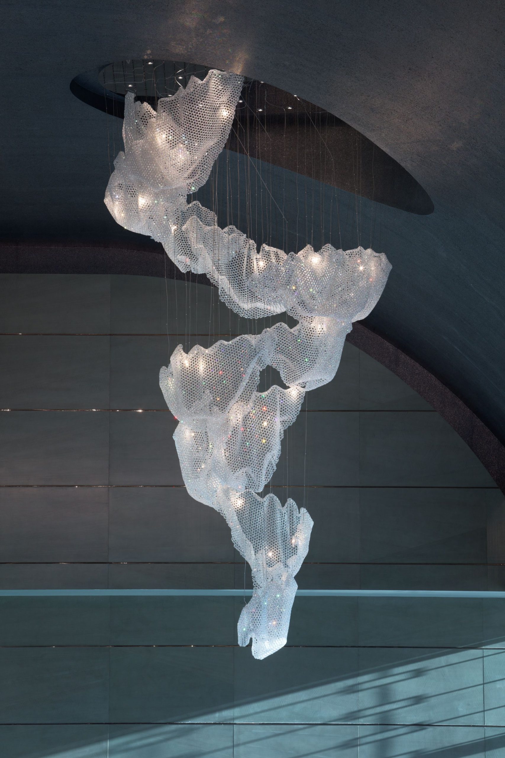 CELESTE crystal sheets above a gold-toned lift lobby
