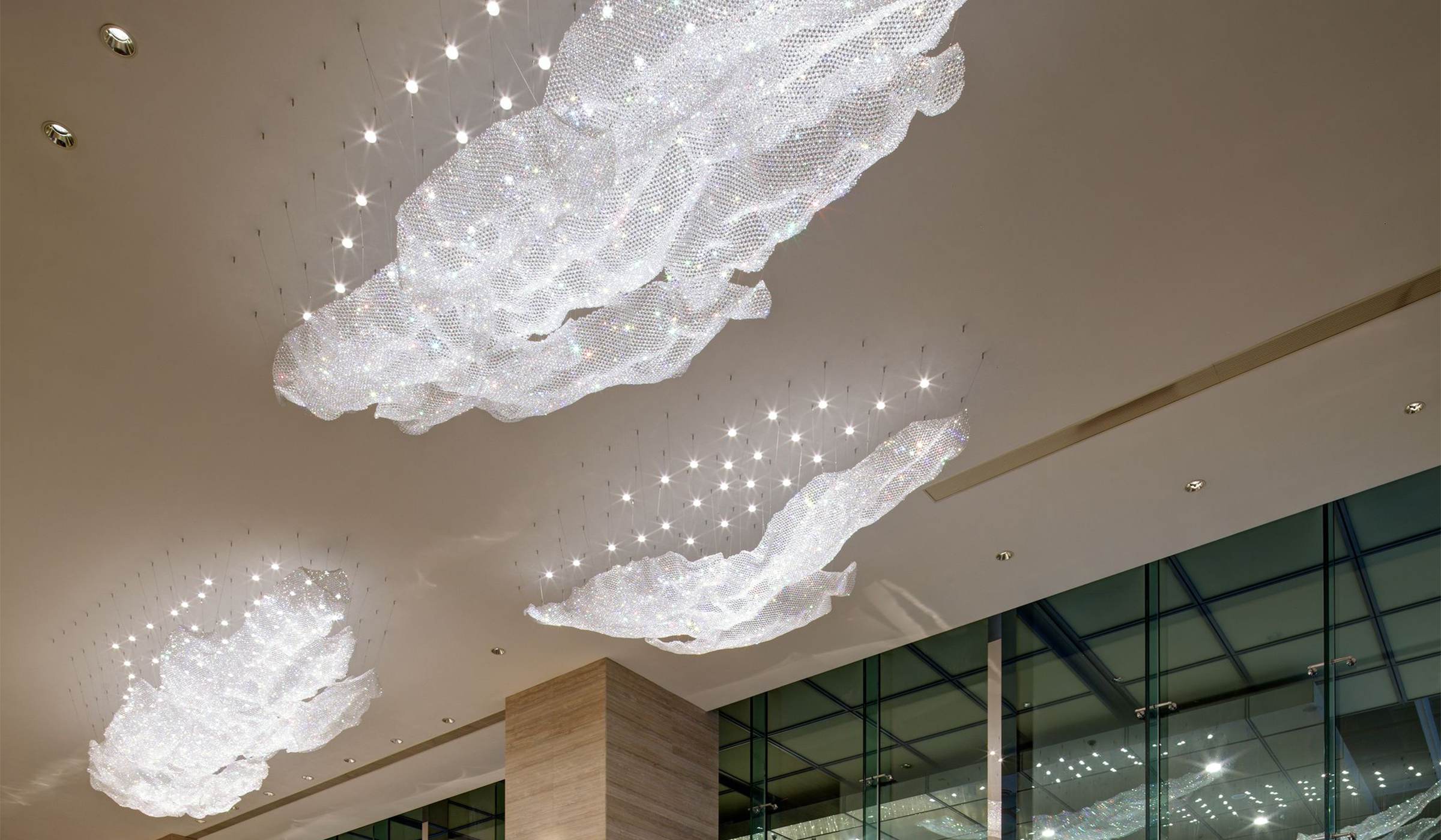 CELESTE crystal sheets over the escalator, window wall behind