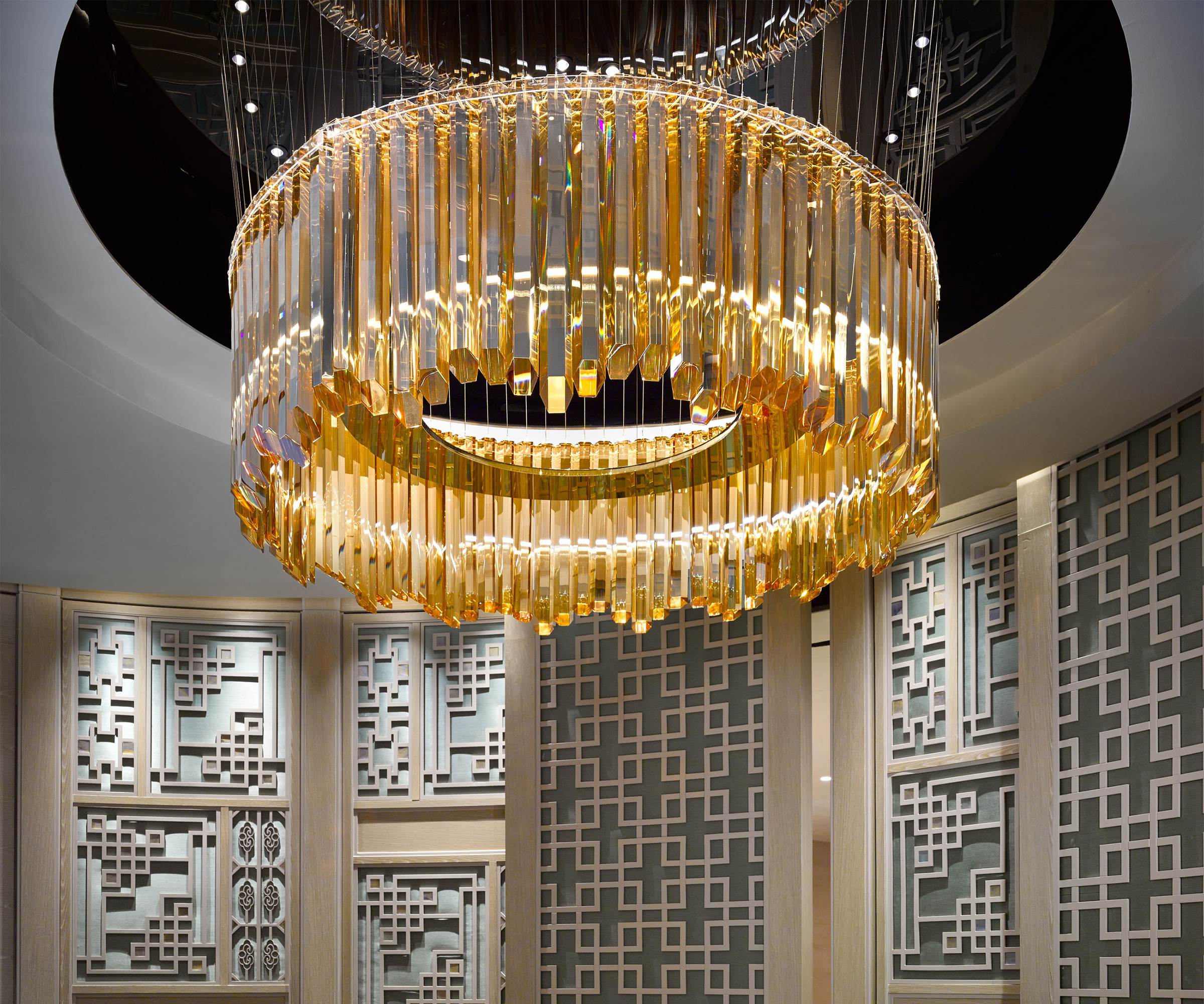 AURELIA amber crystal ring chandelier above a private dining room