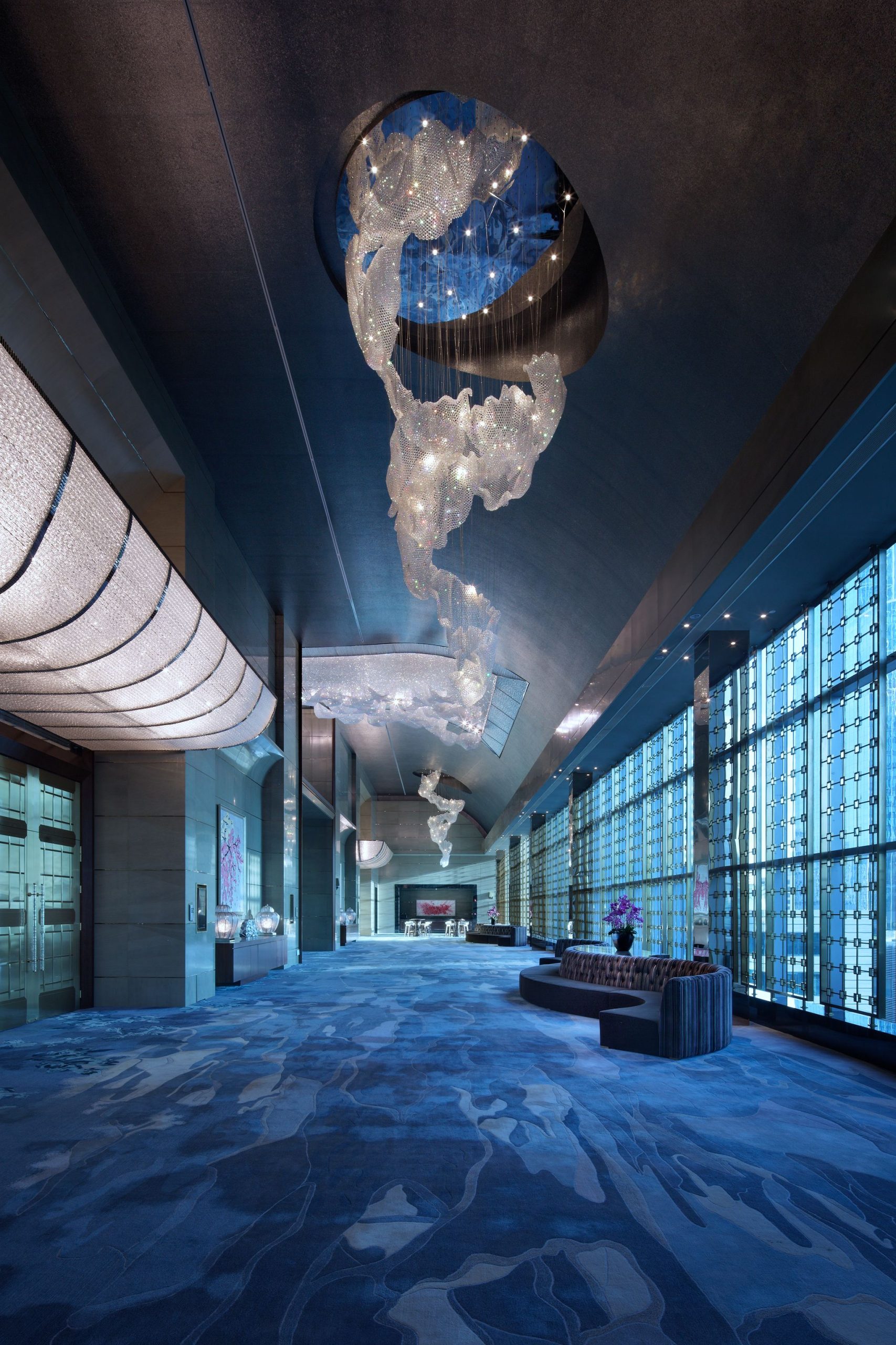ONDINE curved crystal shells running the length of a pre-function corridor