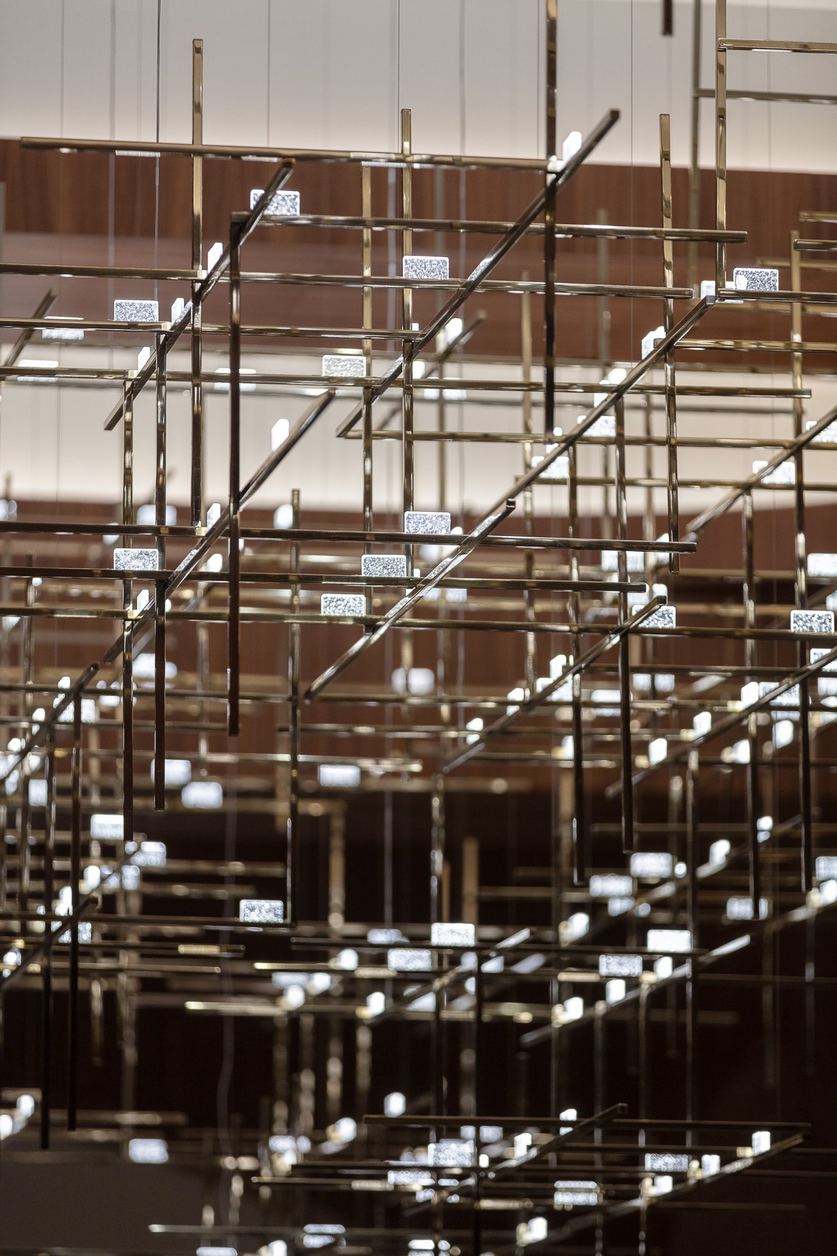BECKETT lounge chandelier reflected on the polished bar counter