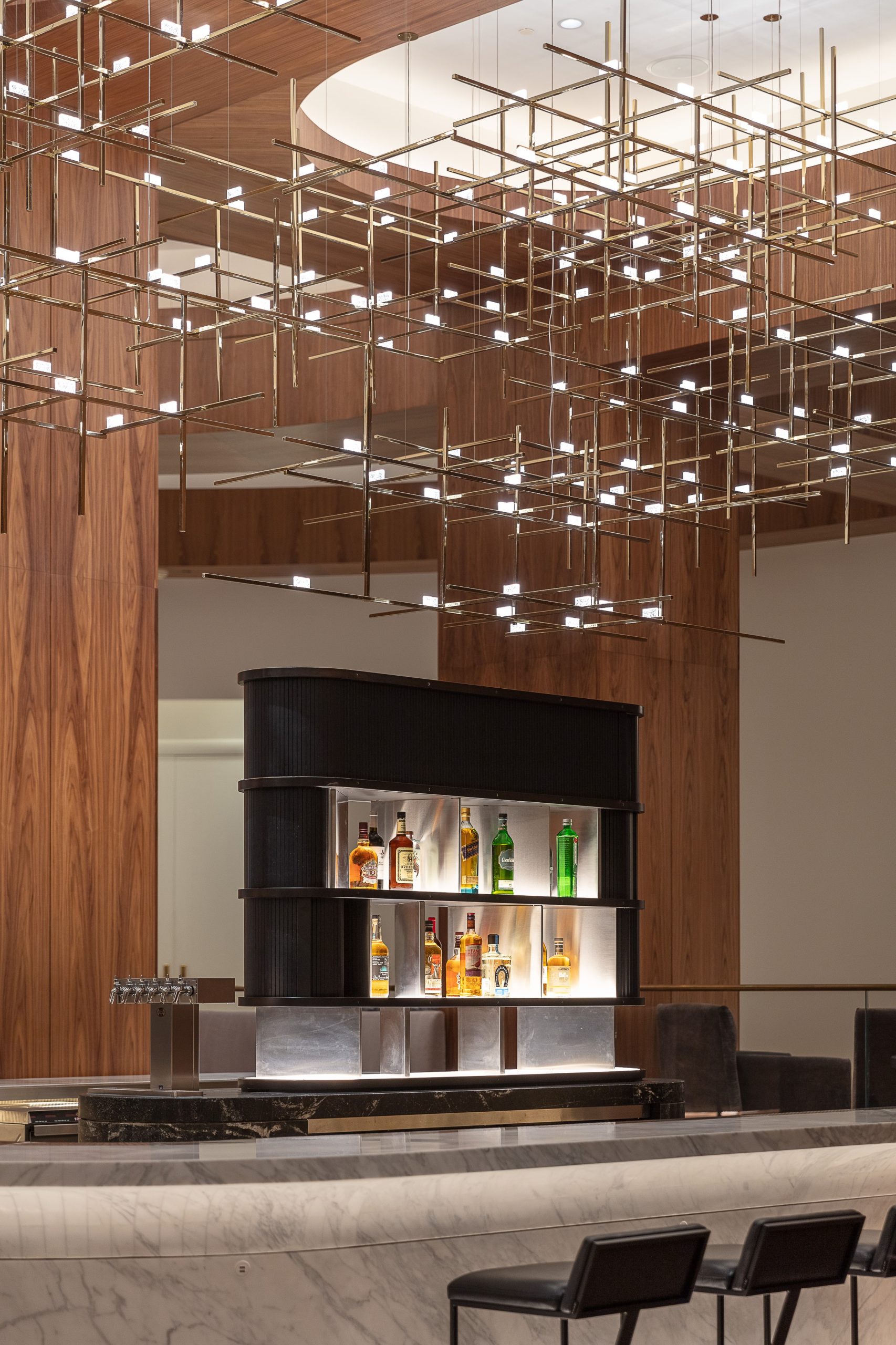 BECKETT rod lattice against the timber-panelled ceiling