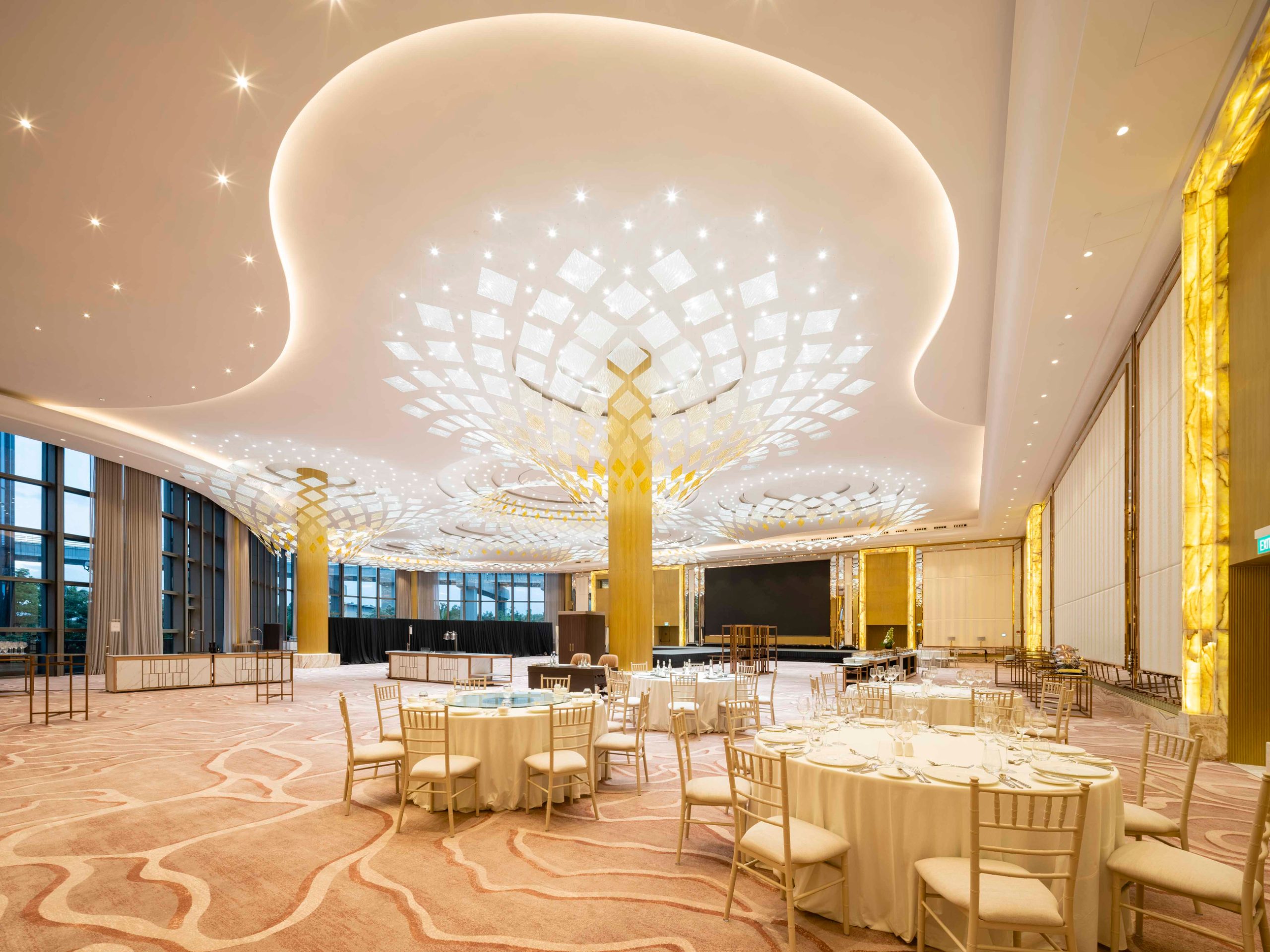 ARBRE lit in a ballroom, wide interior view