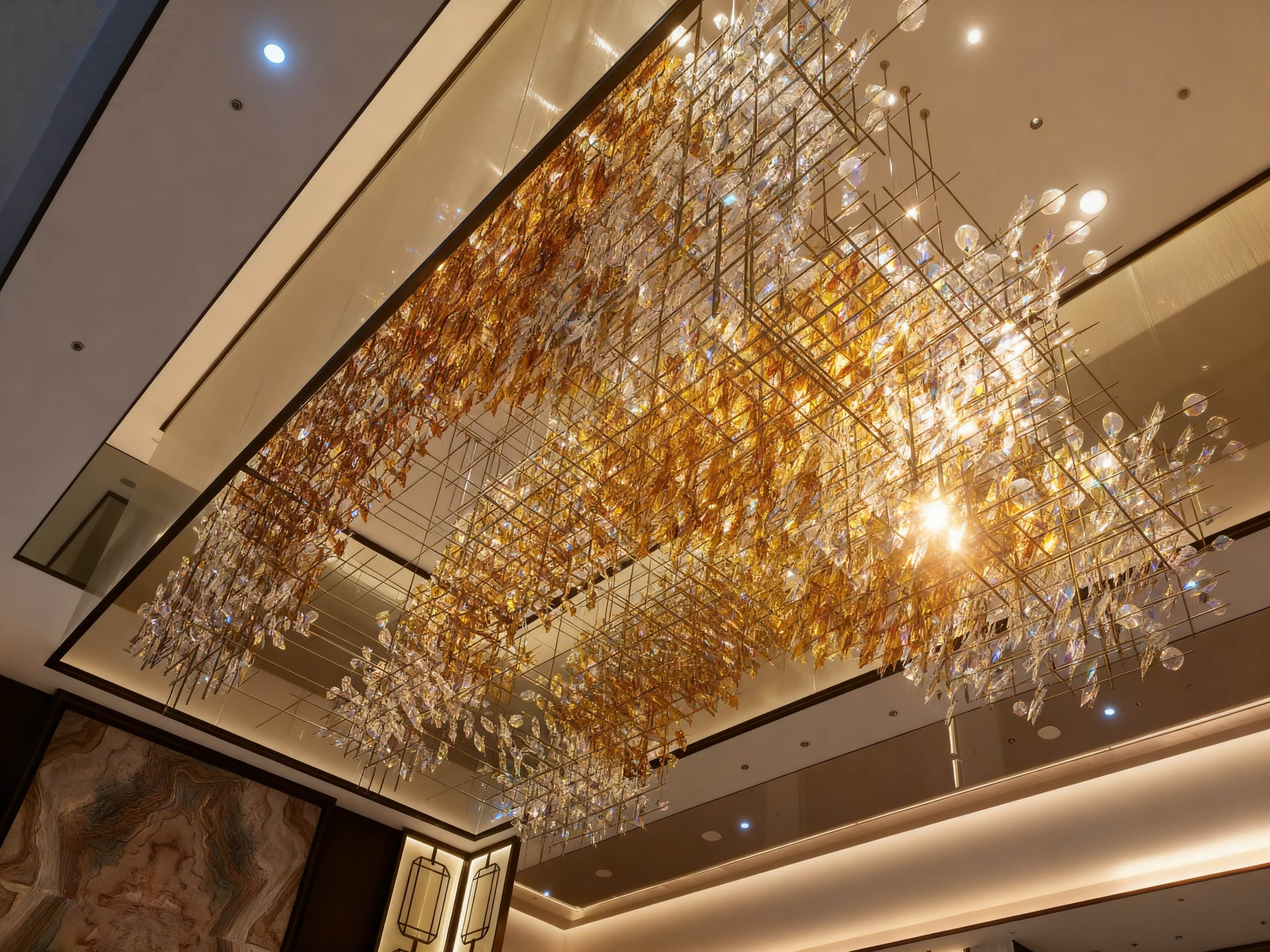 AUTUMNUS custom glass chandelier by SHUCHUANG, full view in a hotel lobby