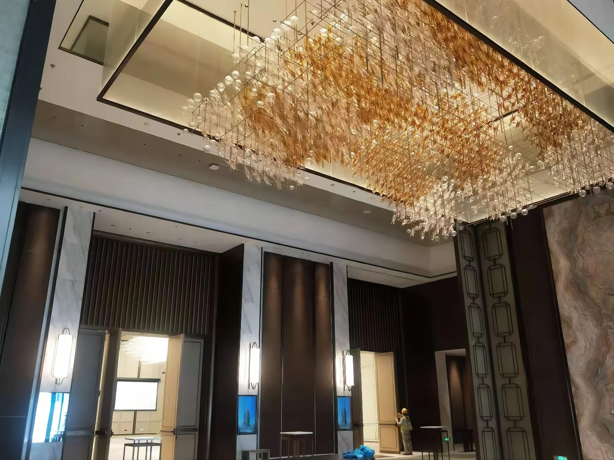 AUTUMNUS lit in a hotel lobby, wide interior view
