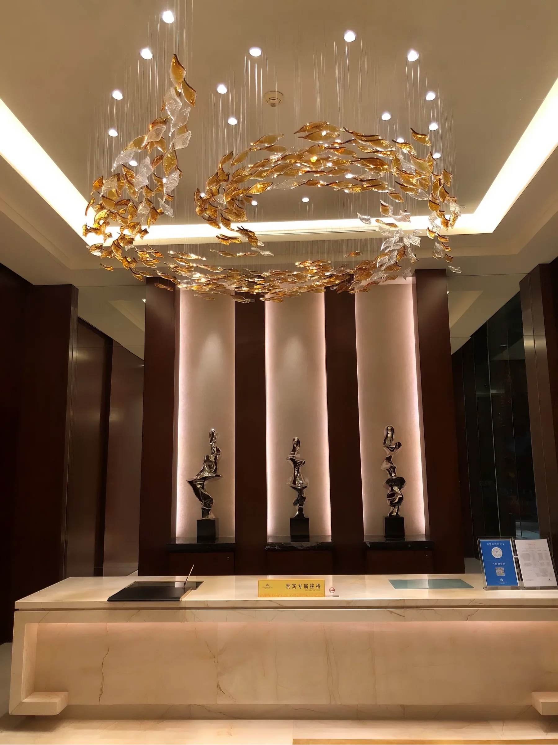 PISCES lit in a hotel lobby, wide interior view