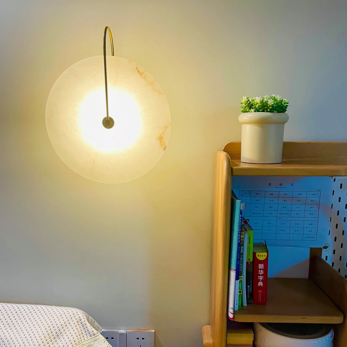 LUCIANA alabaster pendant light lit in a living room