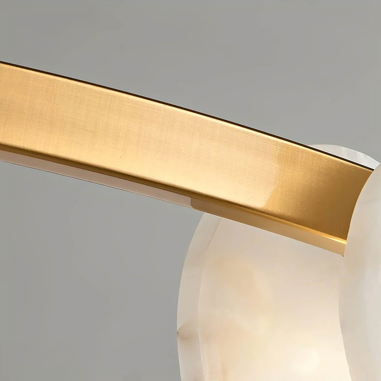 ORION alabaster pendant light hanging over a dining table