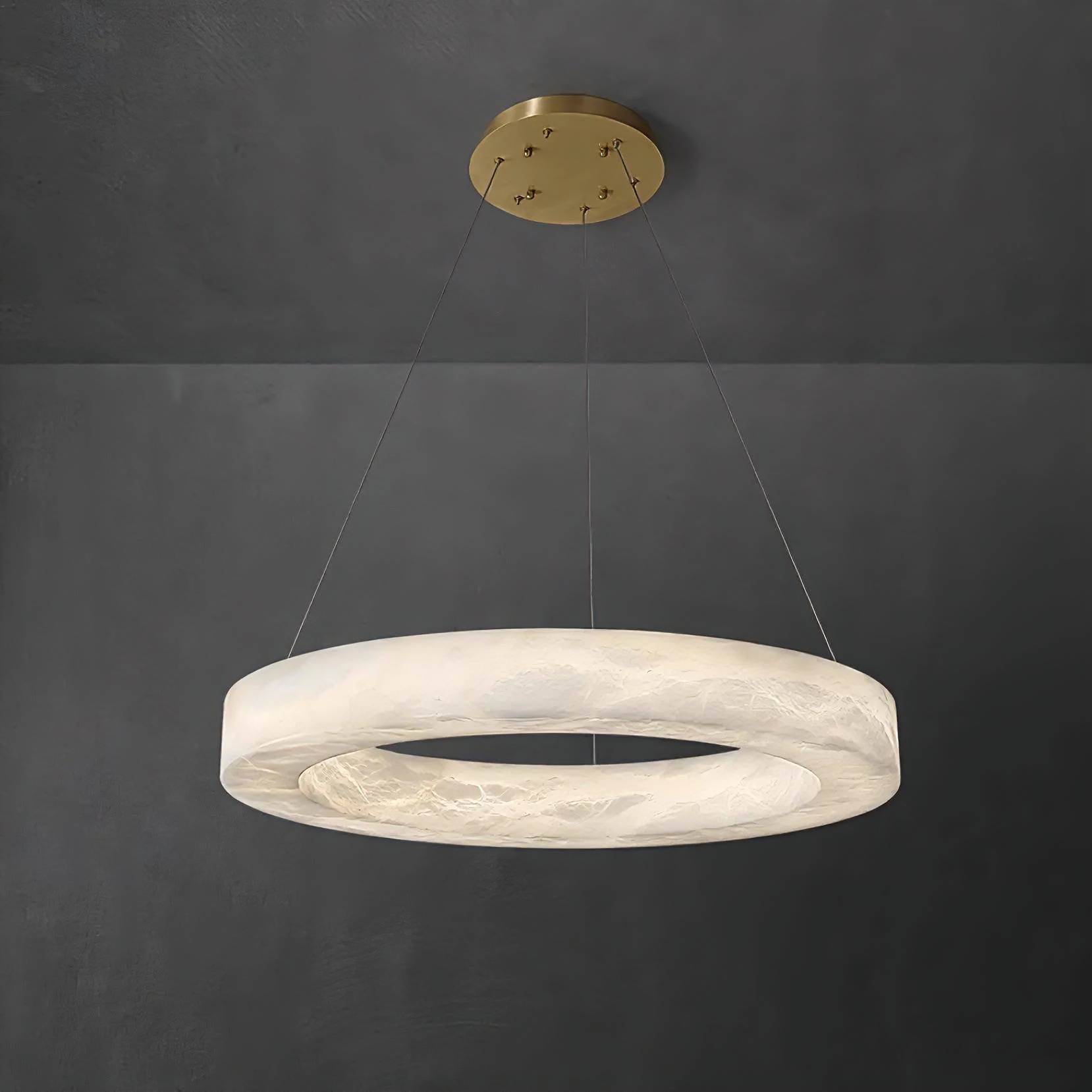 HELIOS alabaster pendant light lit in a living room