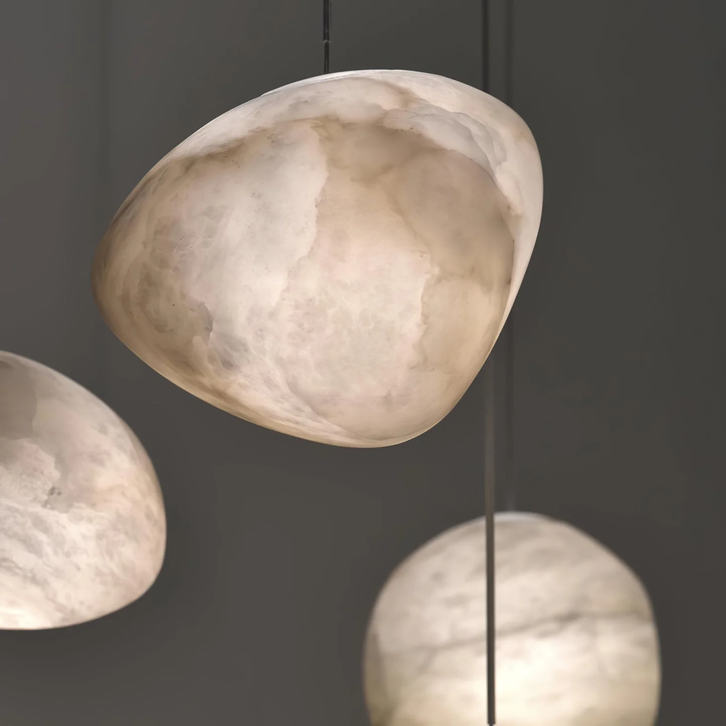DUNE alabaster pendant light lit in a living room