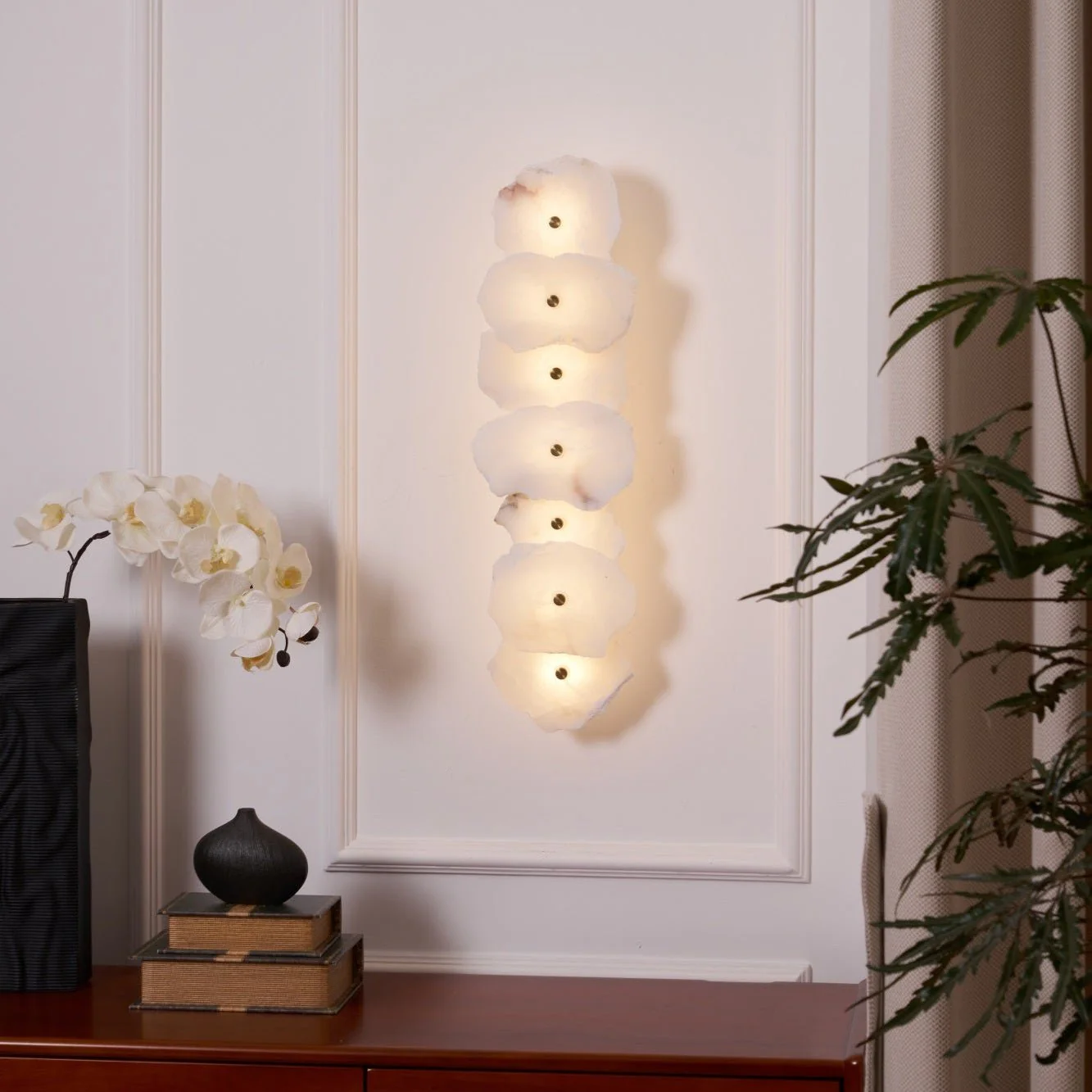 FREYA alabaster pendant light lit in a living room