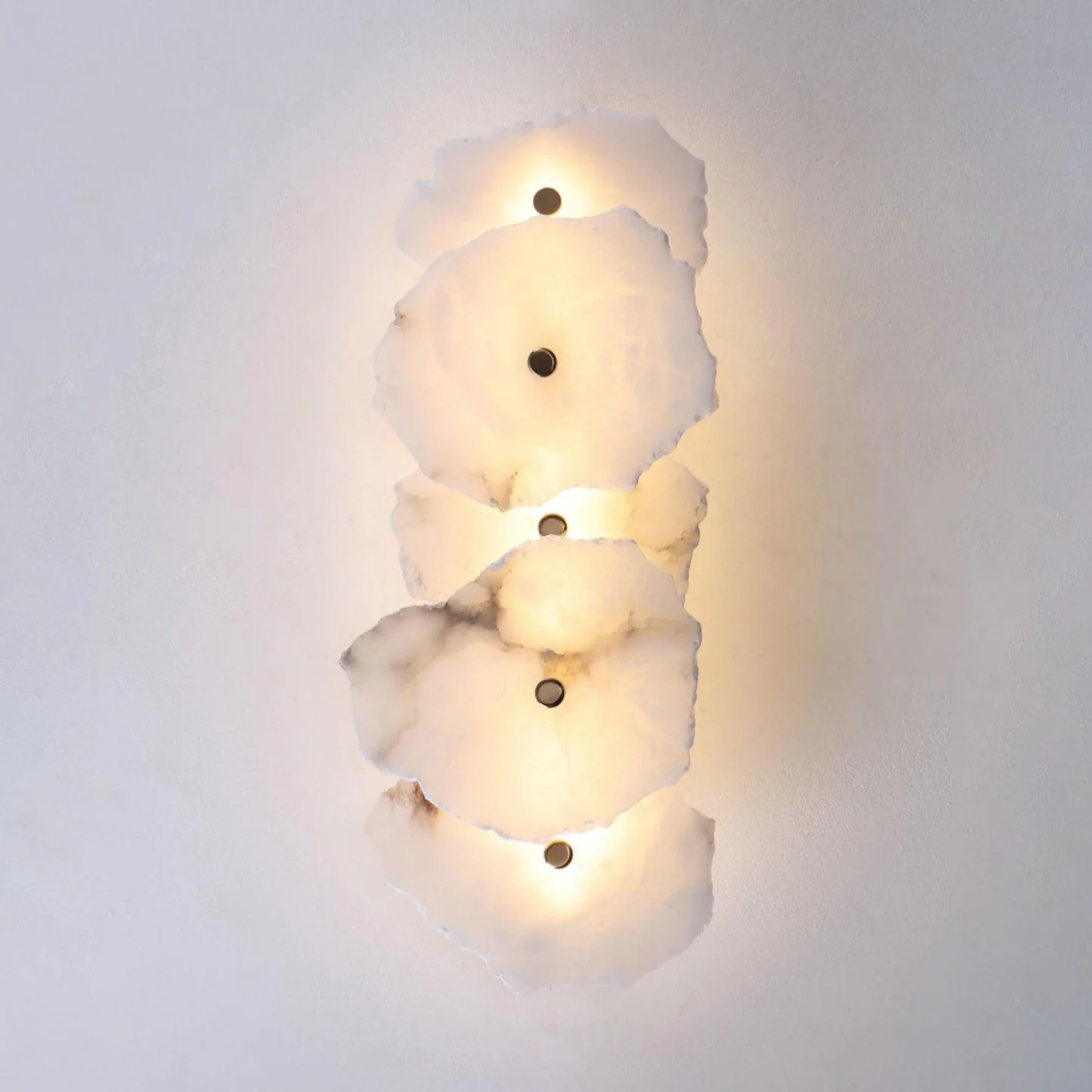 FREYA alabaster pendant light hanging over a dining table