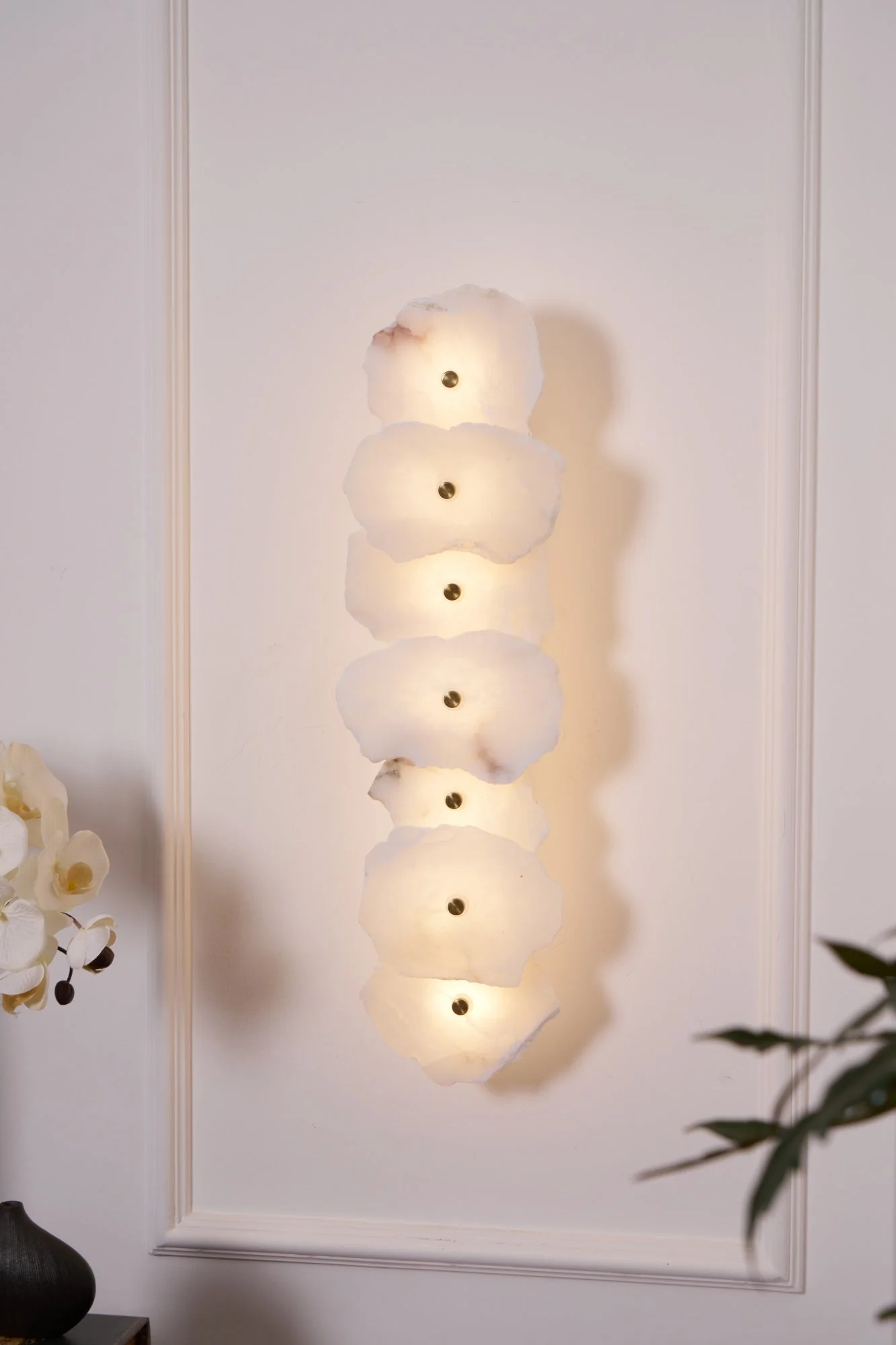 FREYA alabaster pendant light hanging over a dining table