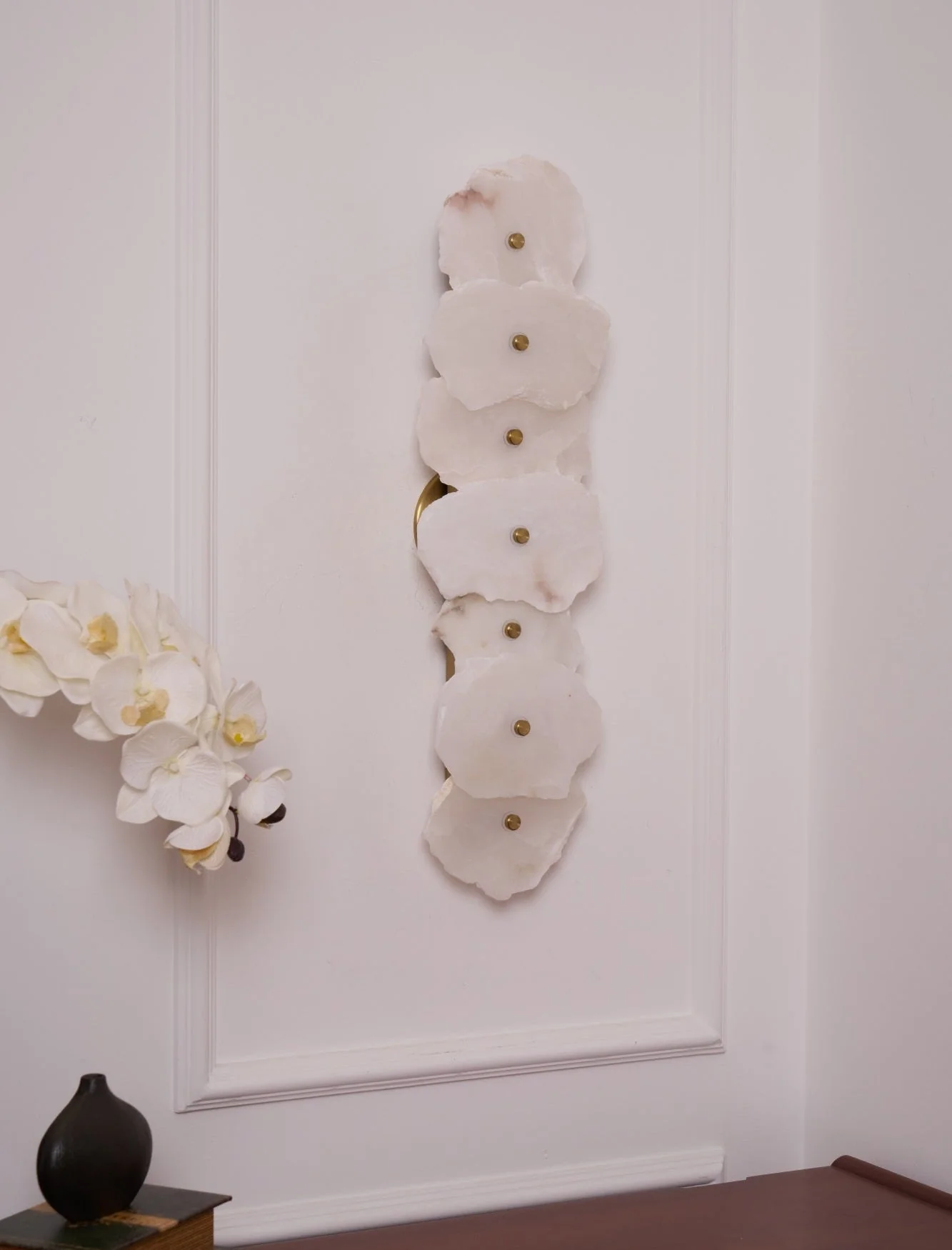 FREYA alabaster pendant light hanging over a dining table