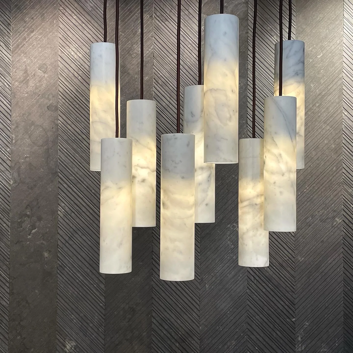 MILAN alabaster pendant light hanging over a dining table