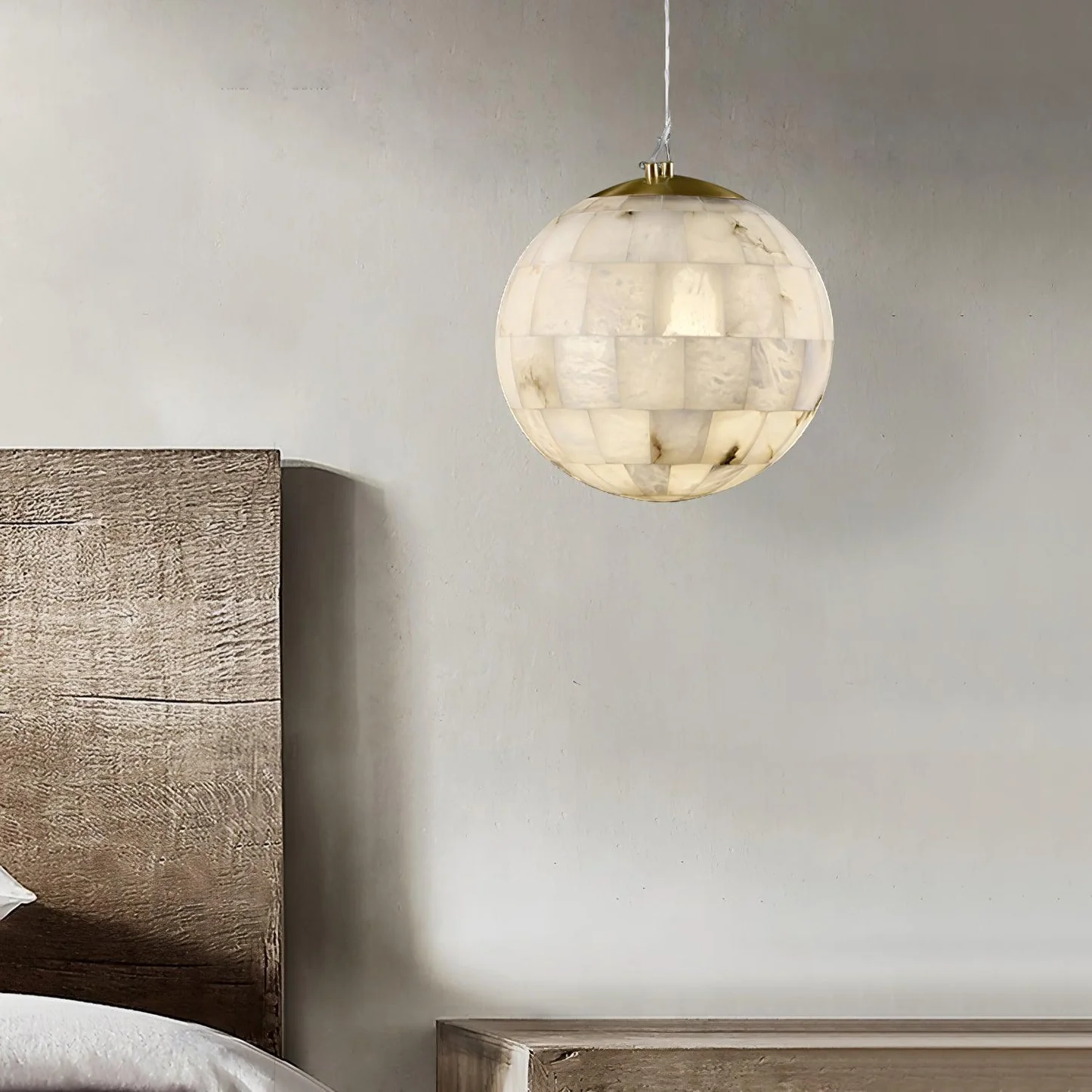SEVILLE alabaster pendant light lit in a living room