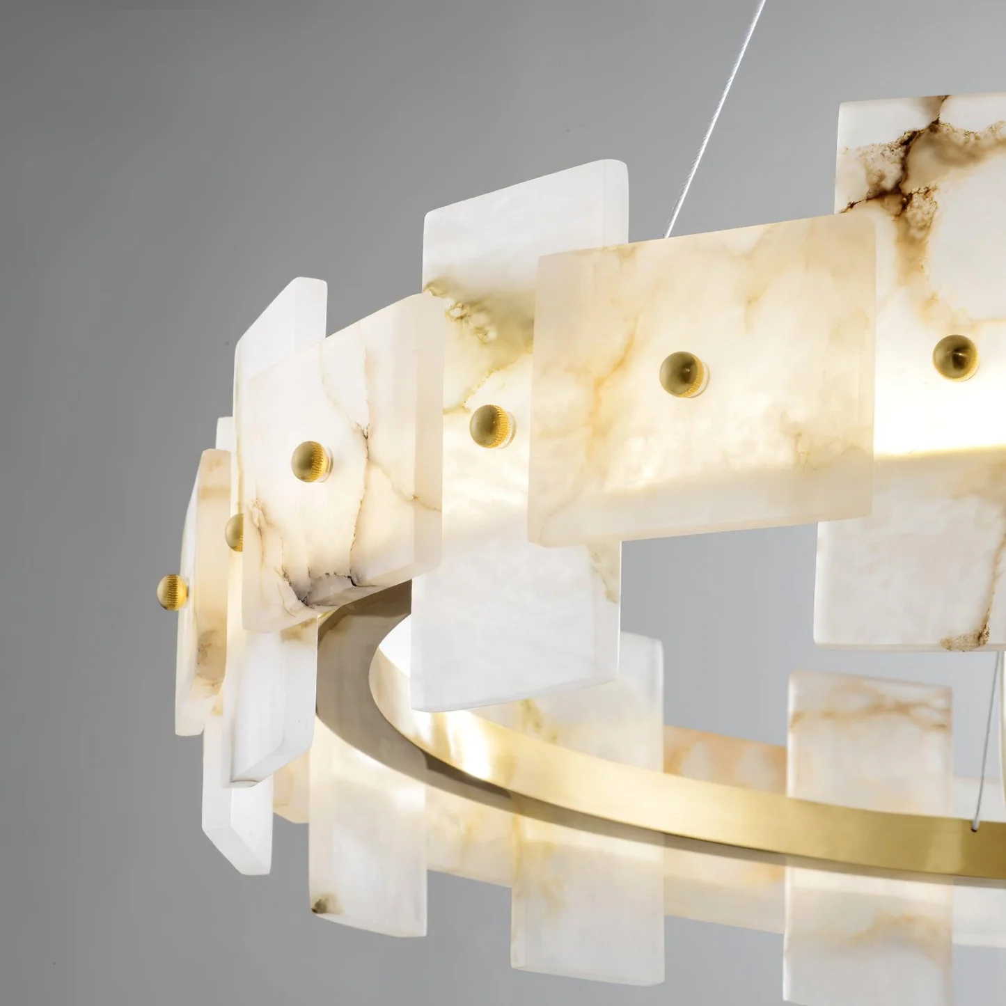 CALEB alabaster pendant light lit in a living room
