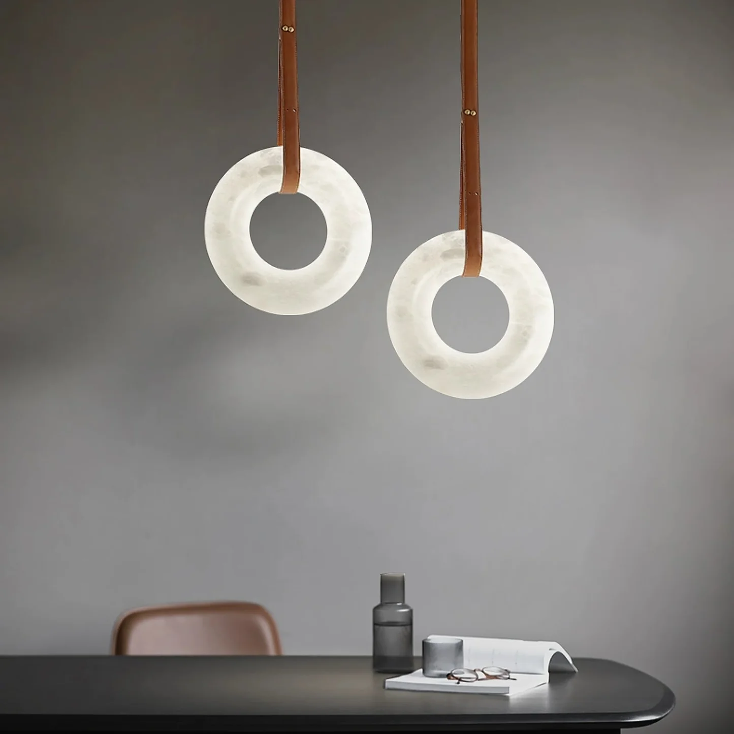 LAREDO alabaster pendant light hanging over a dining table
